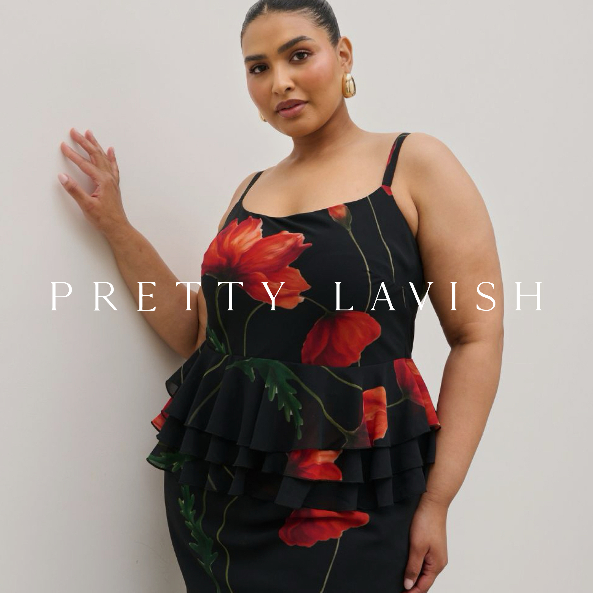 Model wears matching floral top and skirt in black and red from Pretty Lavish