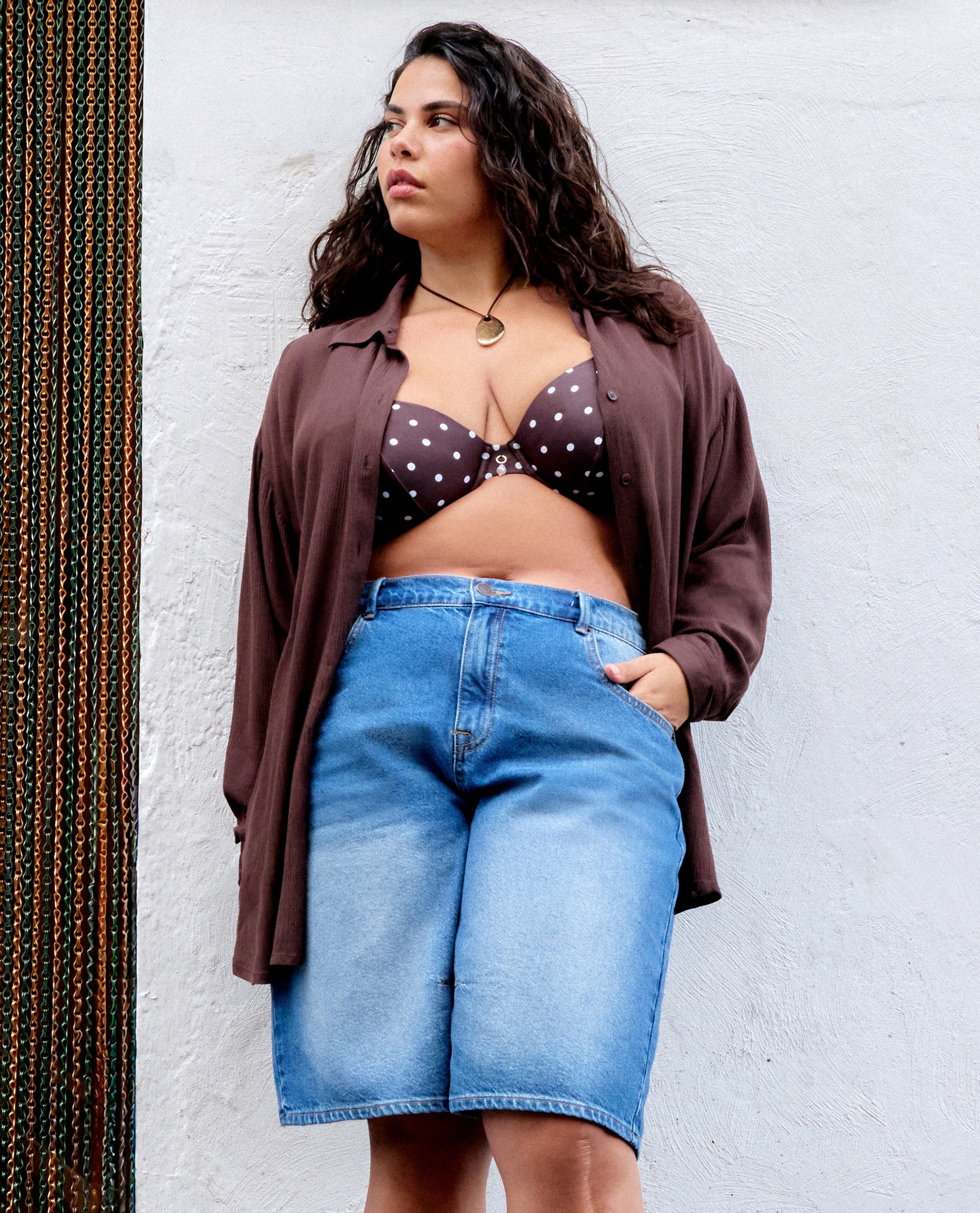 Model wears Mid Wash Denim Bermuda Shorts
