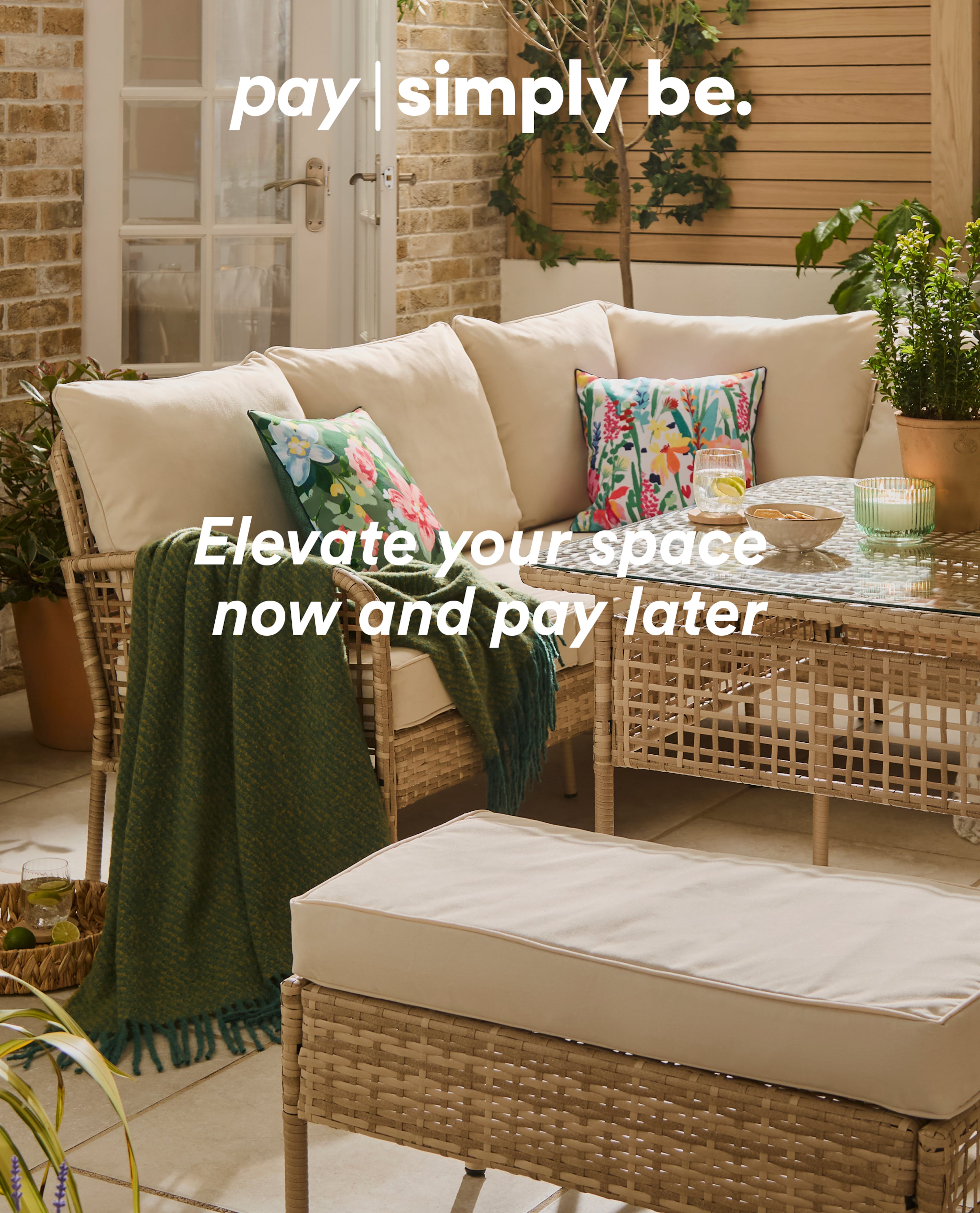 Wicker patio lounge set with cushions, throw and drinks, featuring.