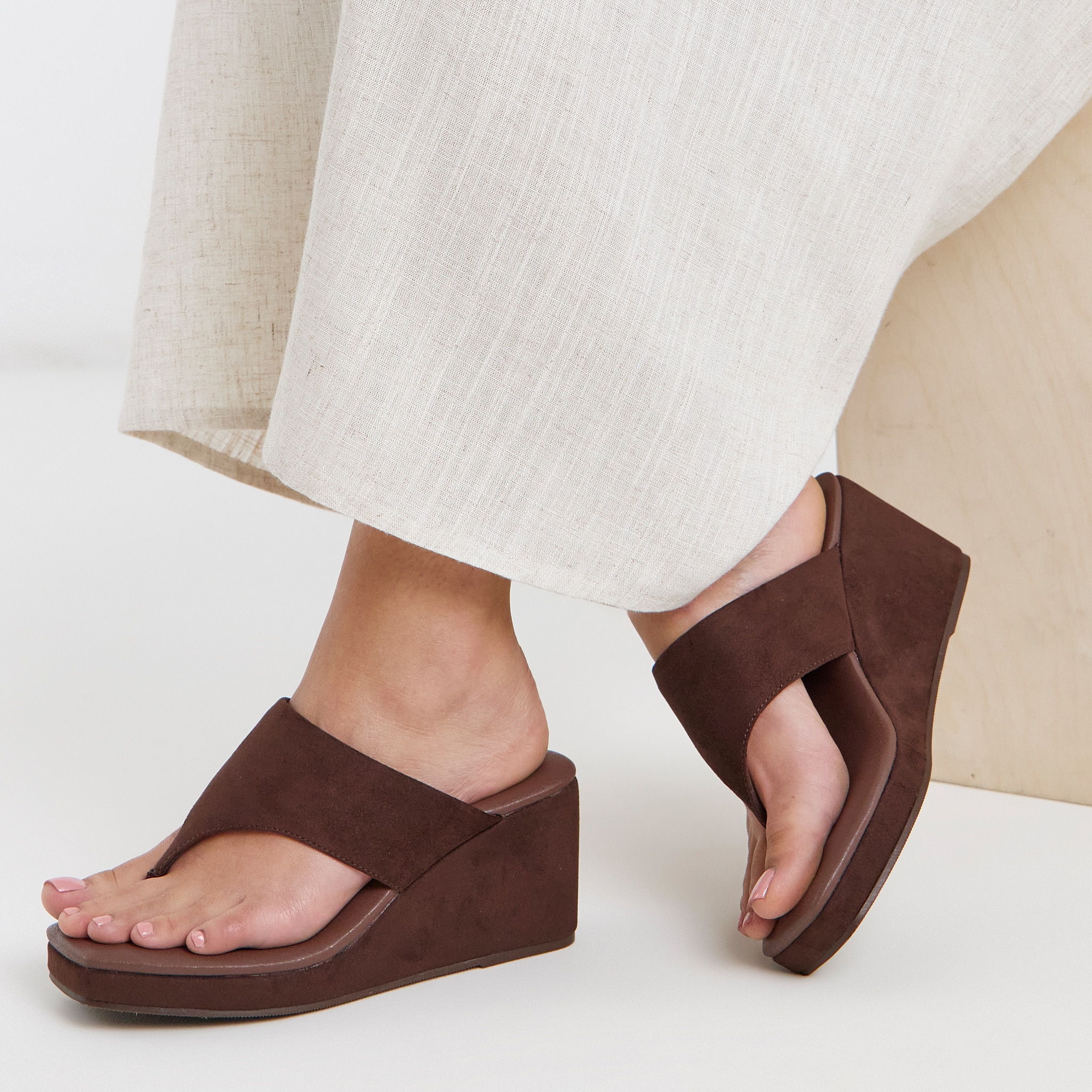 model wearing cream trousers wedge brown sandal
