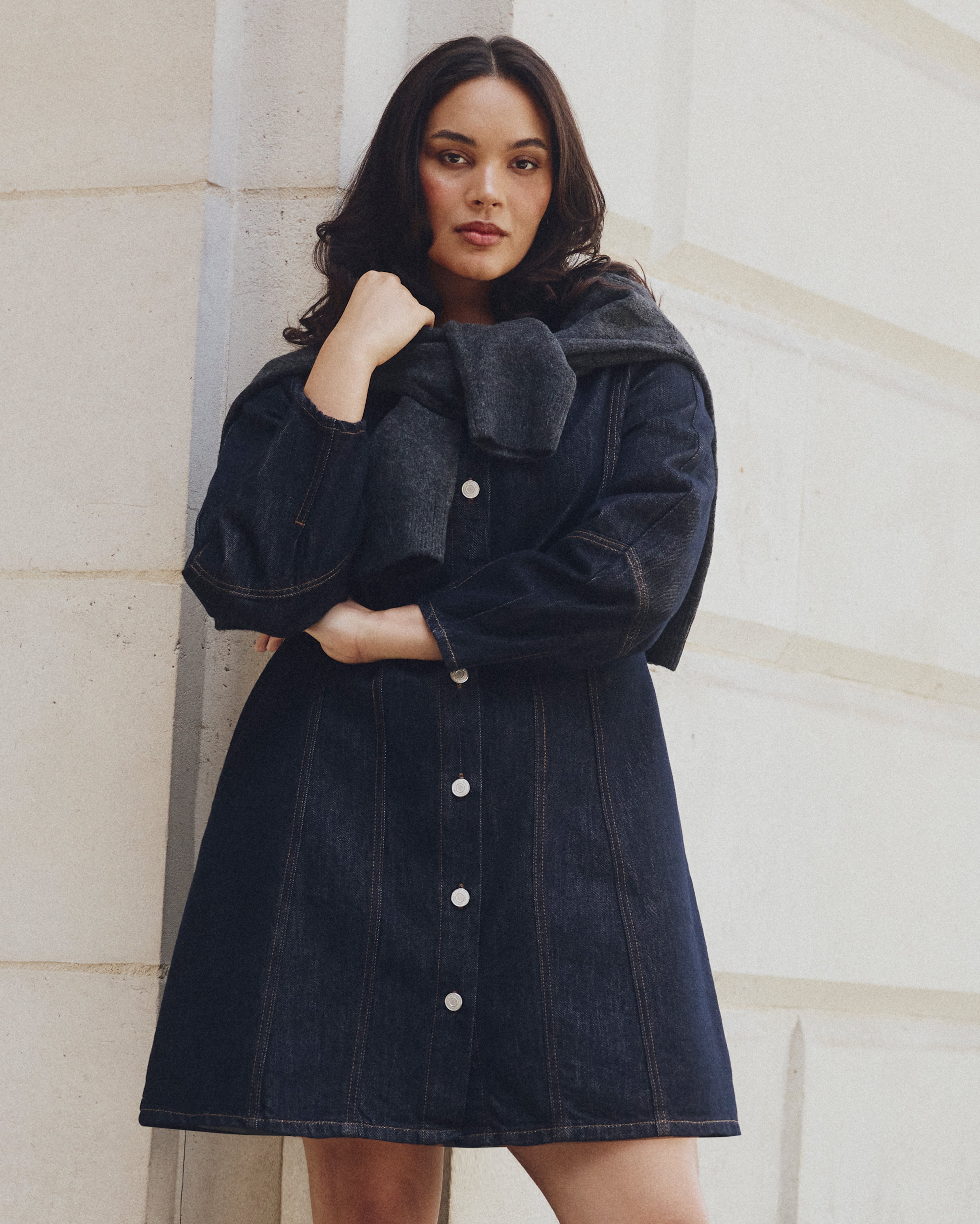 Model wears dark demin dress