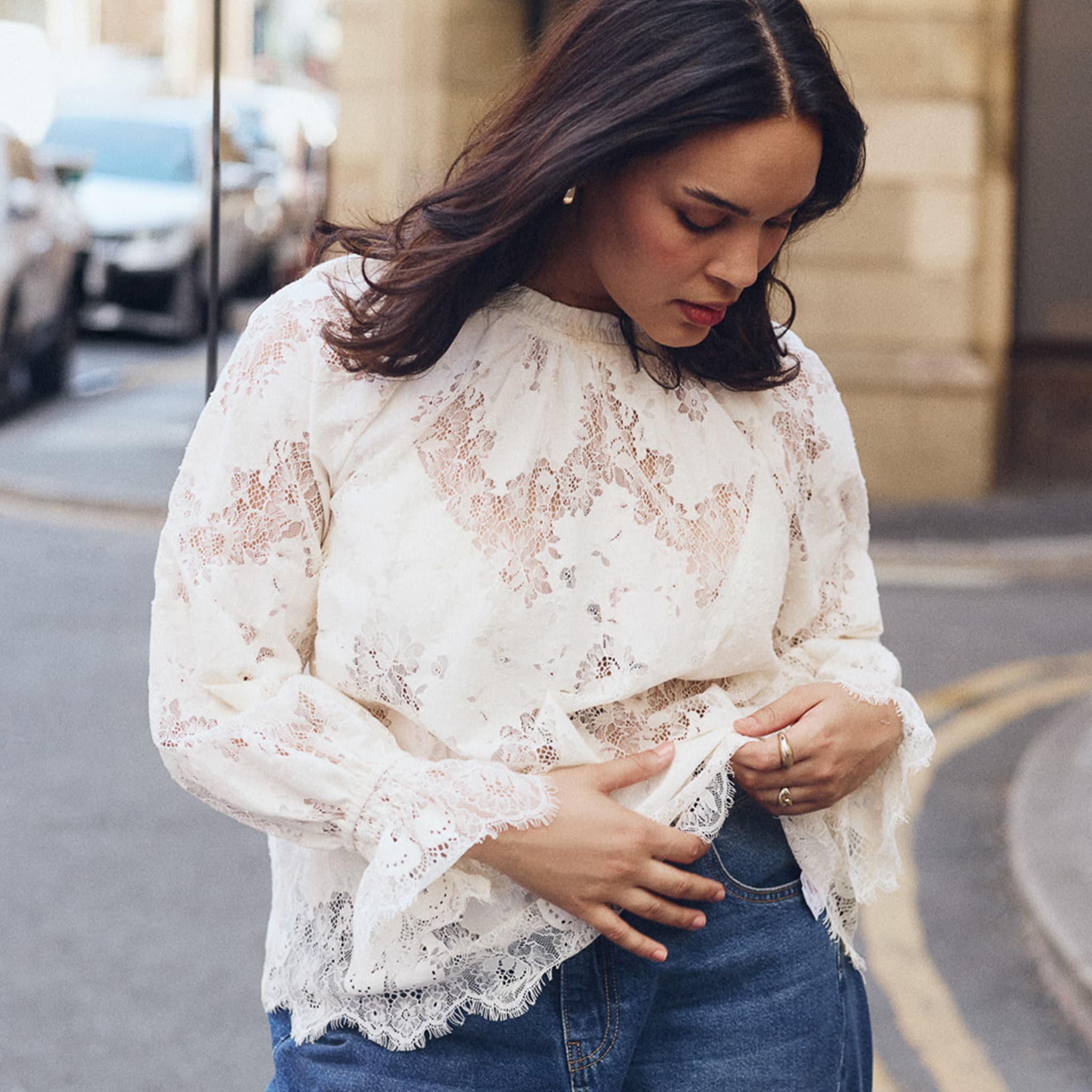 Model is wearing an Simply Be ivory lace long sleeve top.