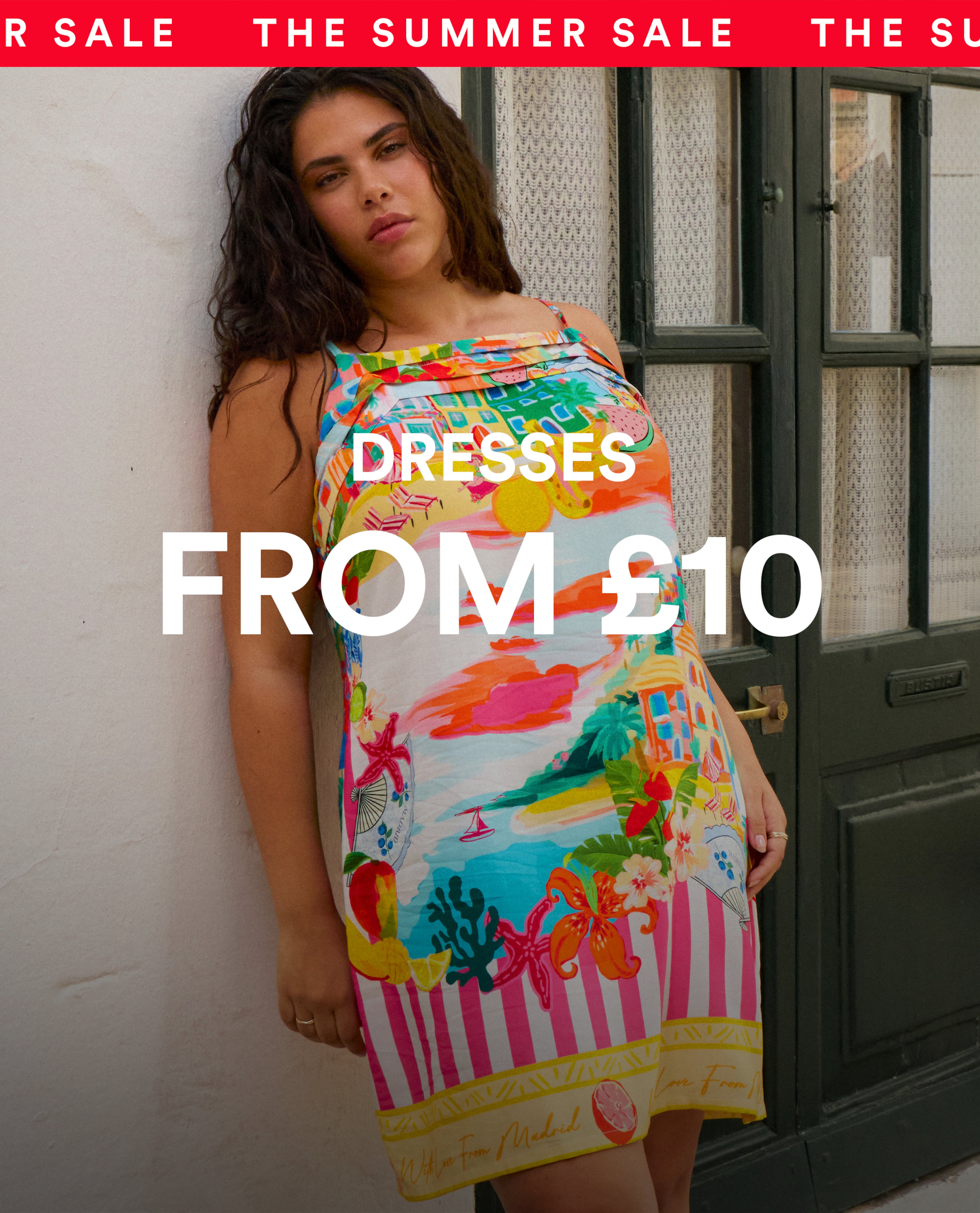 Woman wearing a colourful printed strappy dress.