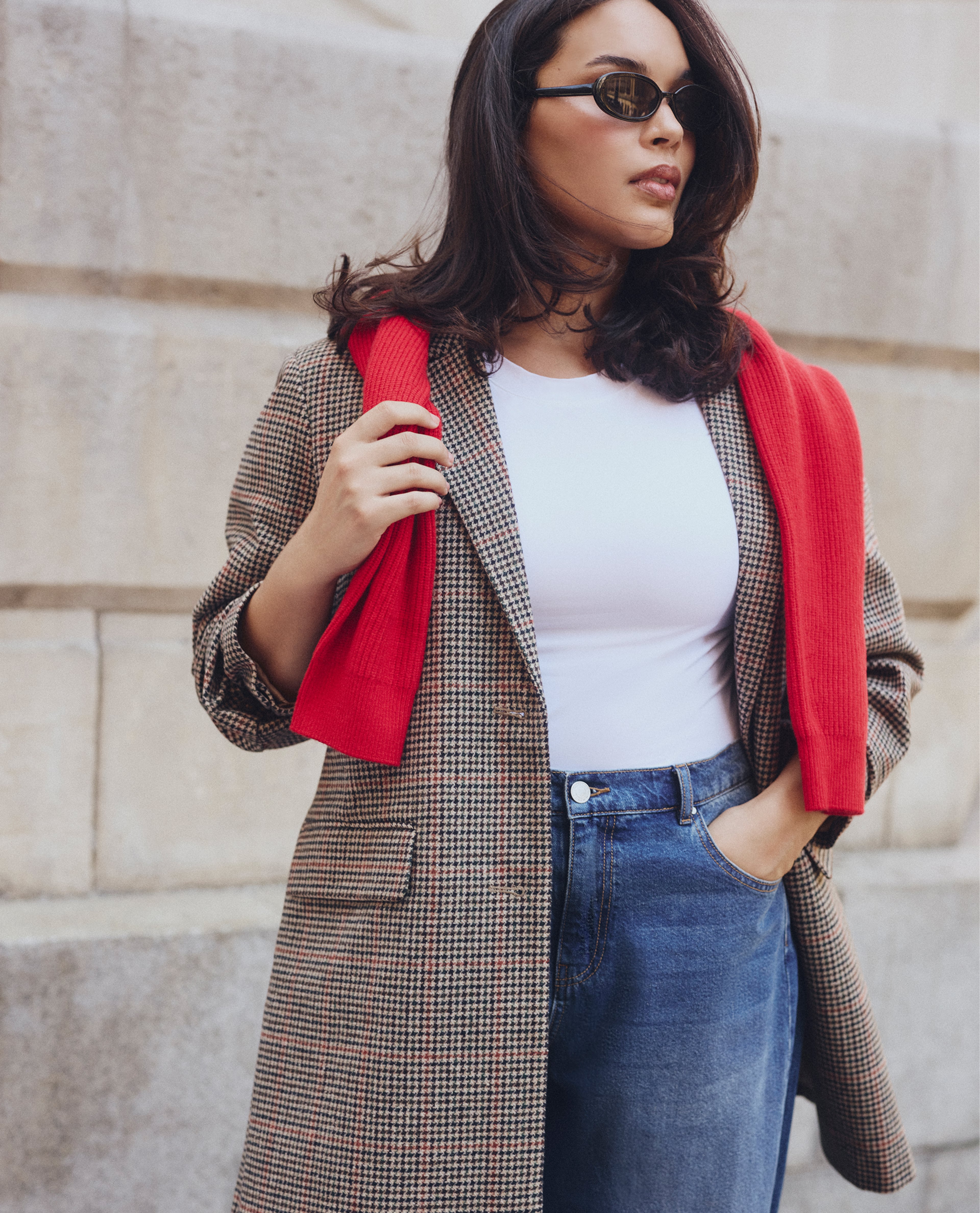 Model wears longline tailored jacket in a check pattern