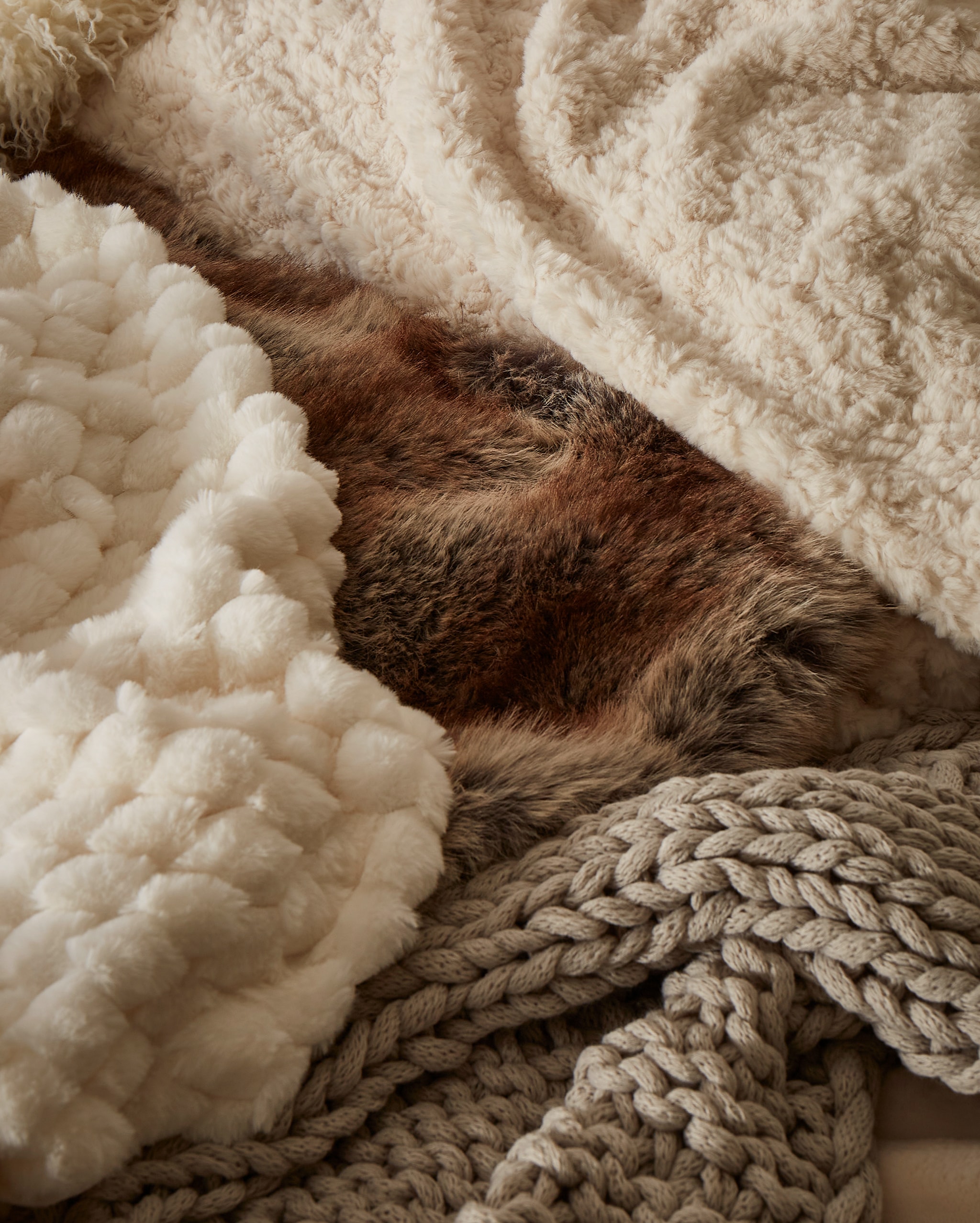 Various cosy blankets in beige in natural colours