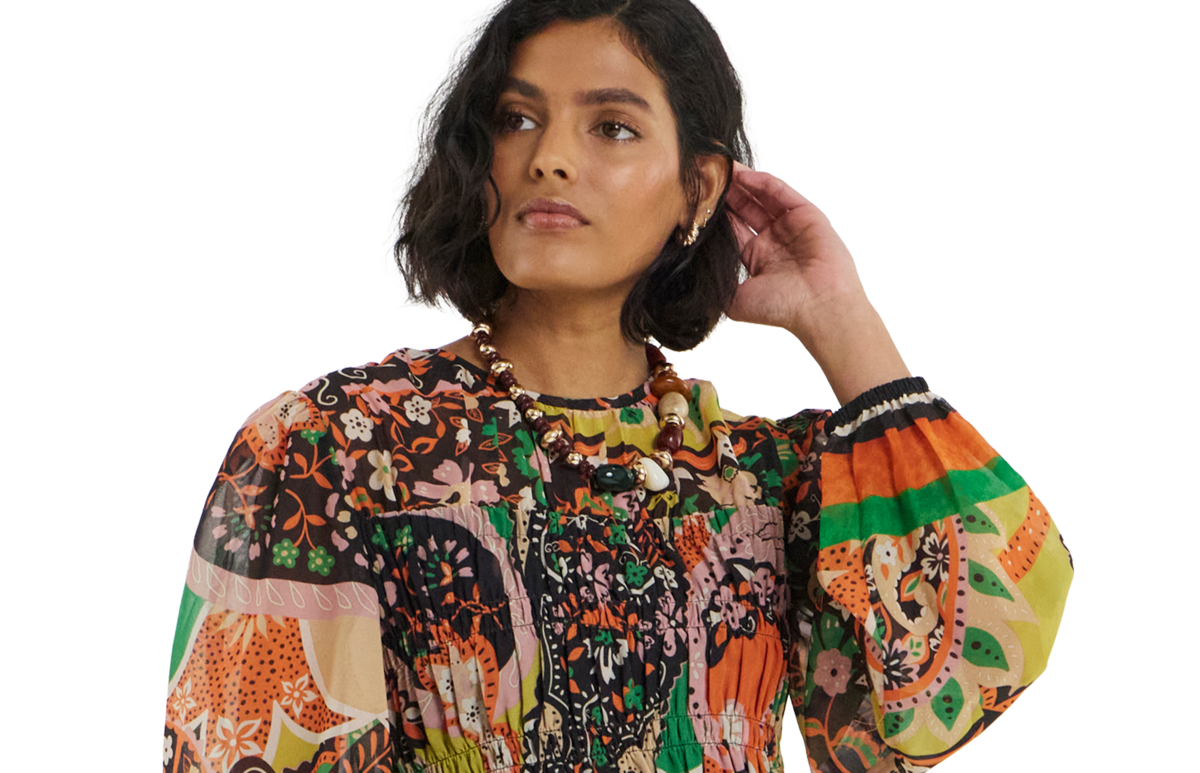 model wearing floral dress hand touching hair