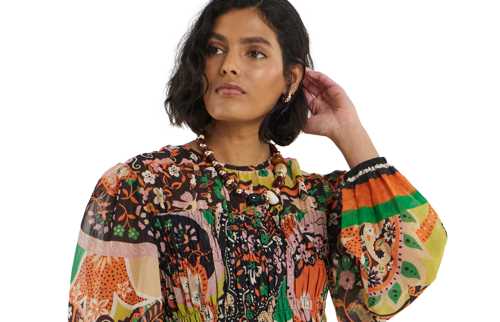 model wearing floral dress hand touching hair