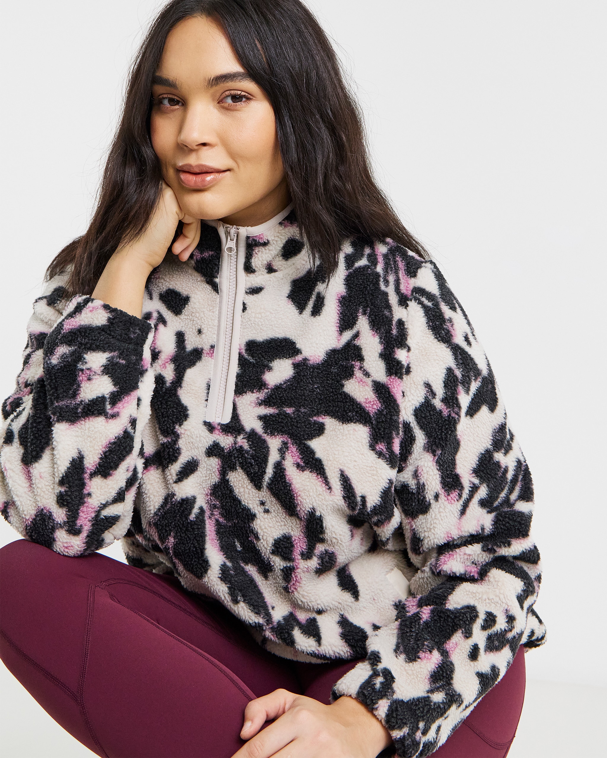 Model wears quarter zip fleece in black and whie