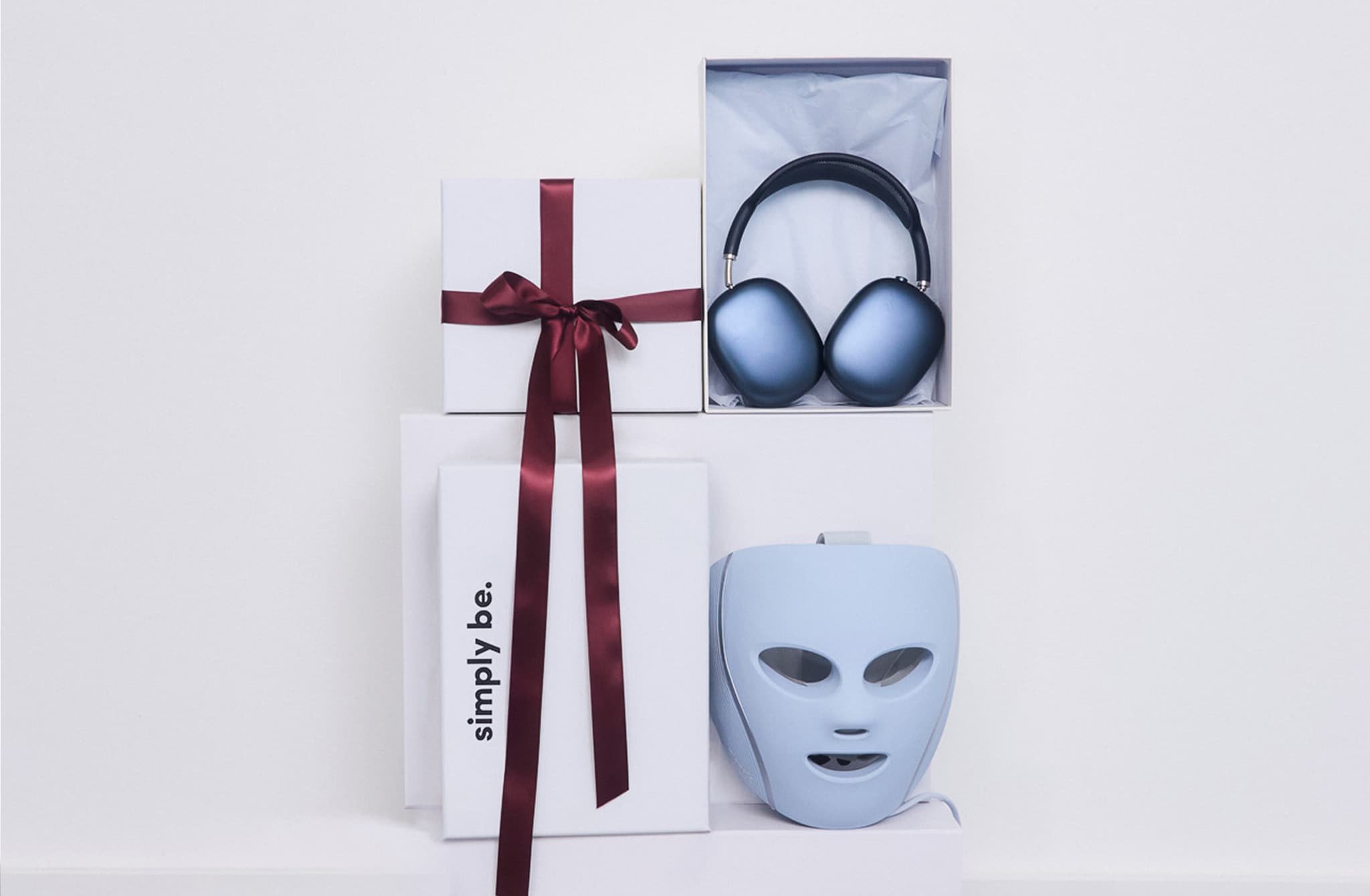 Shark CryoGlow Under-Eye Cooling & LED Anti-Ageing & Blemish Repair Mask - Lilac is pictured with Apple Headphones