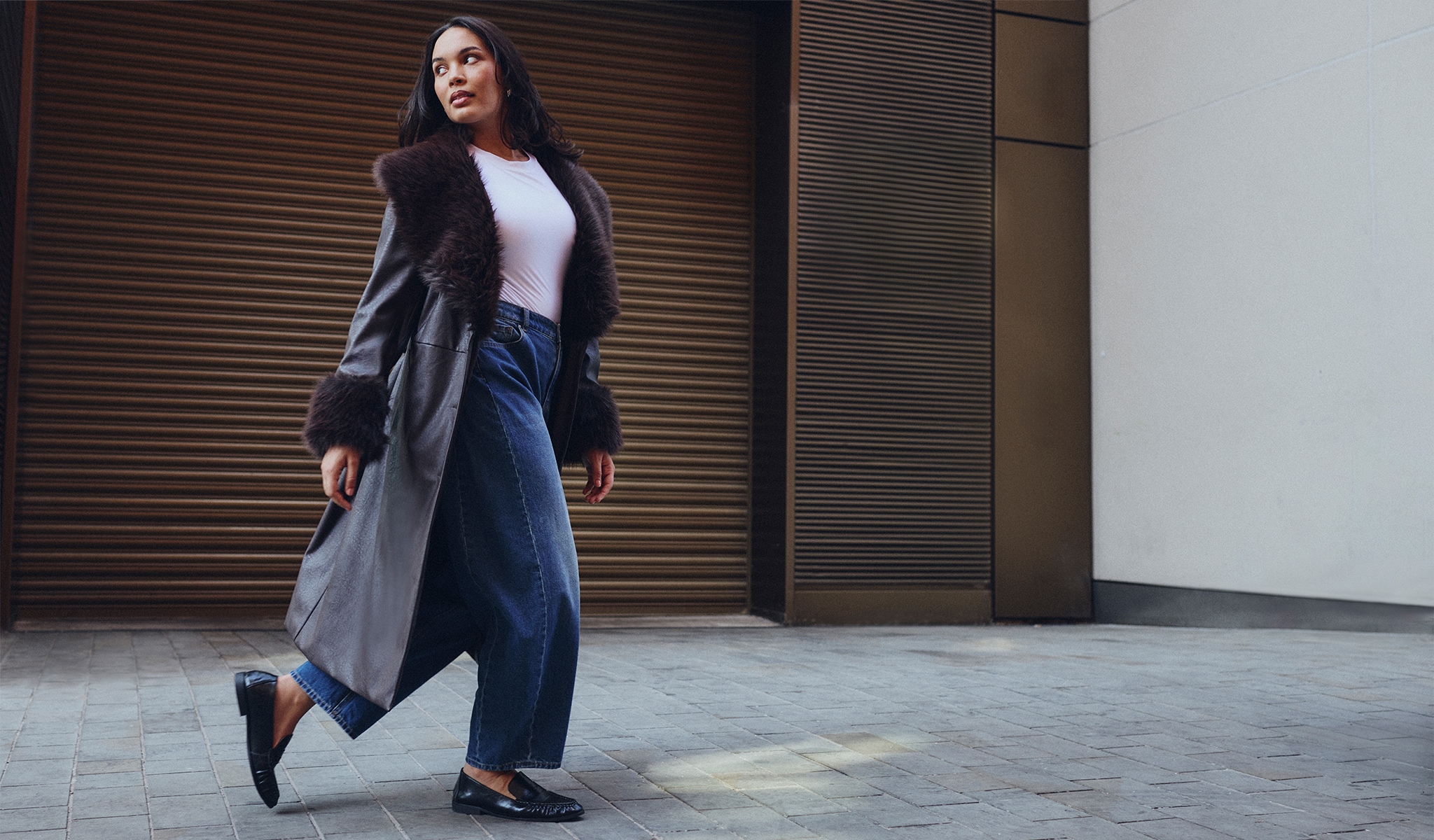 Model wears new season long coat with faux fur lining