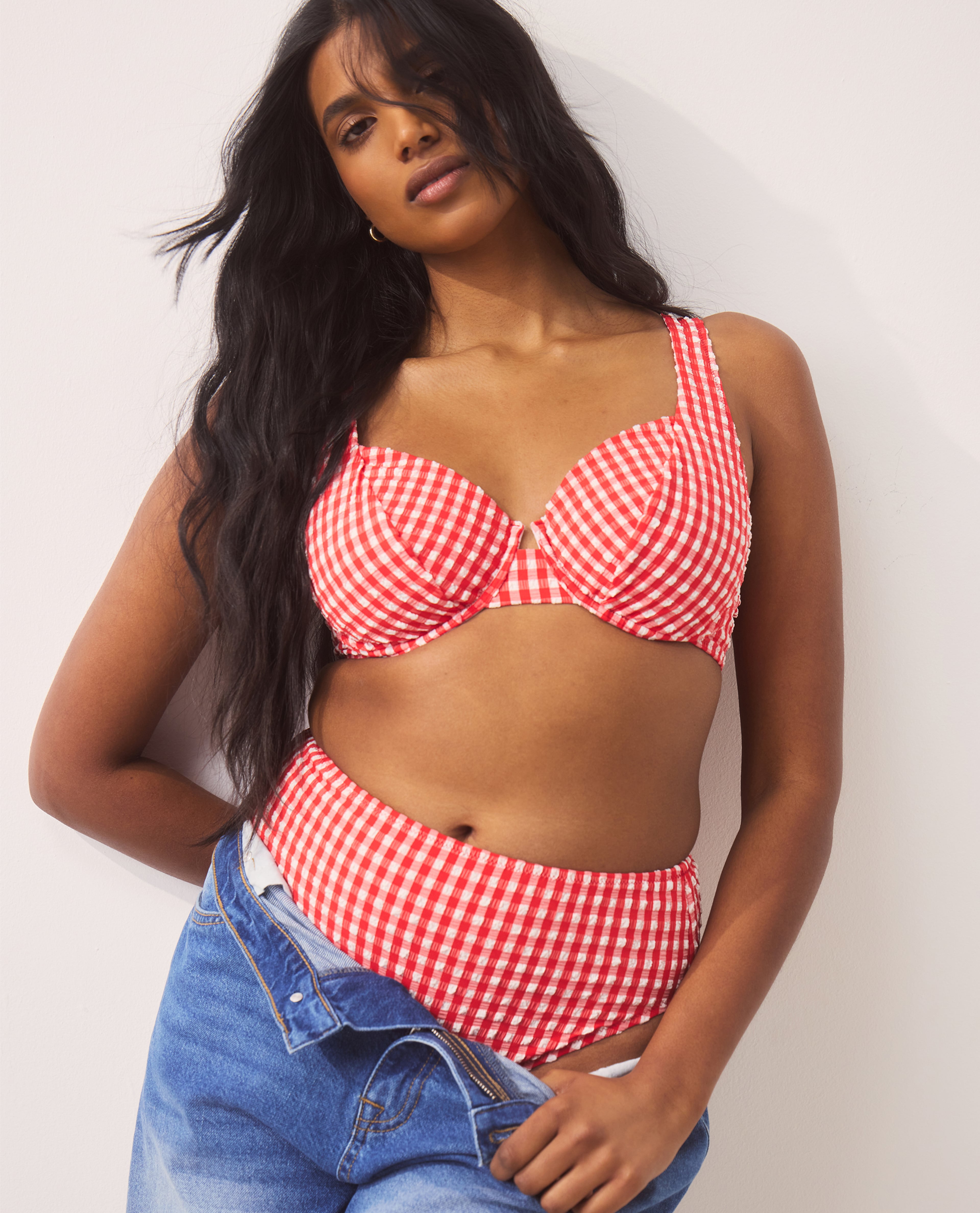 Model wears red gingham swimwear set