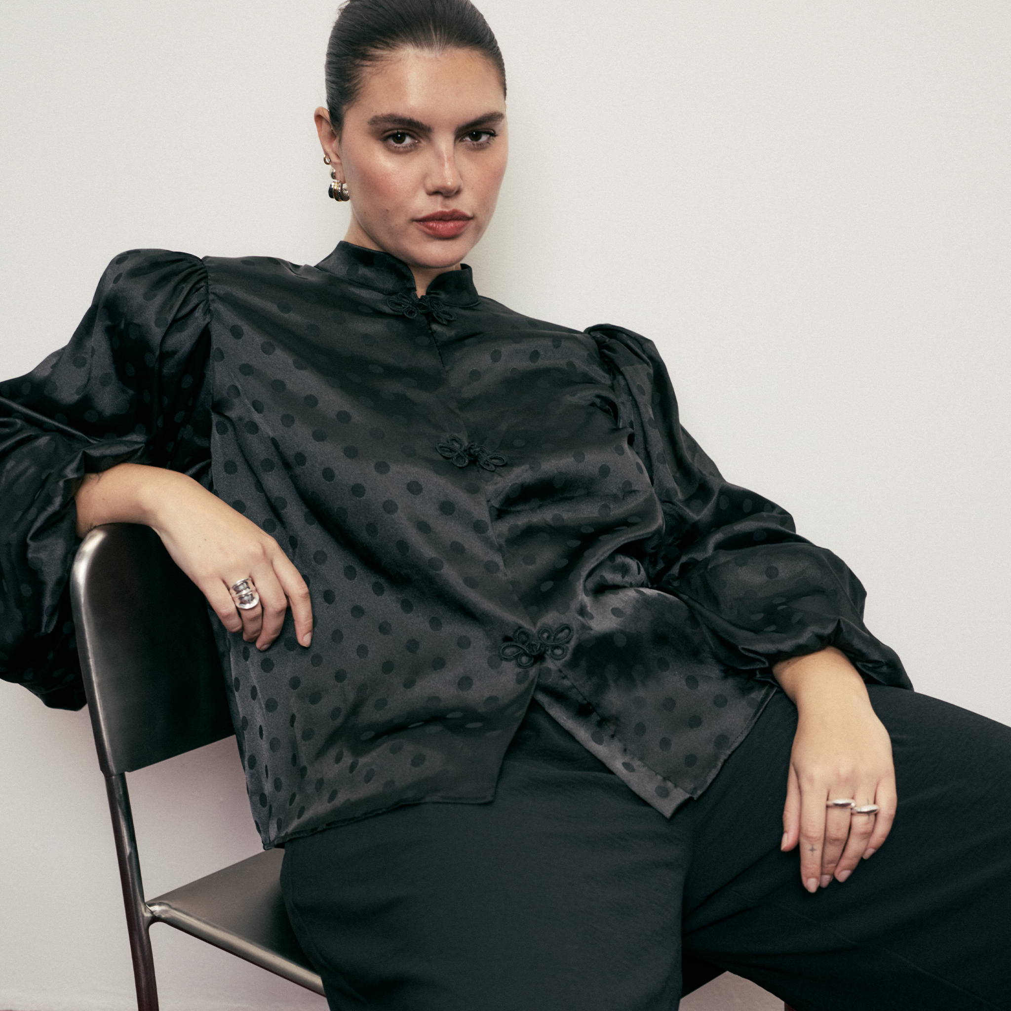 model wearing black xmas top on chair