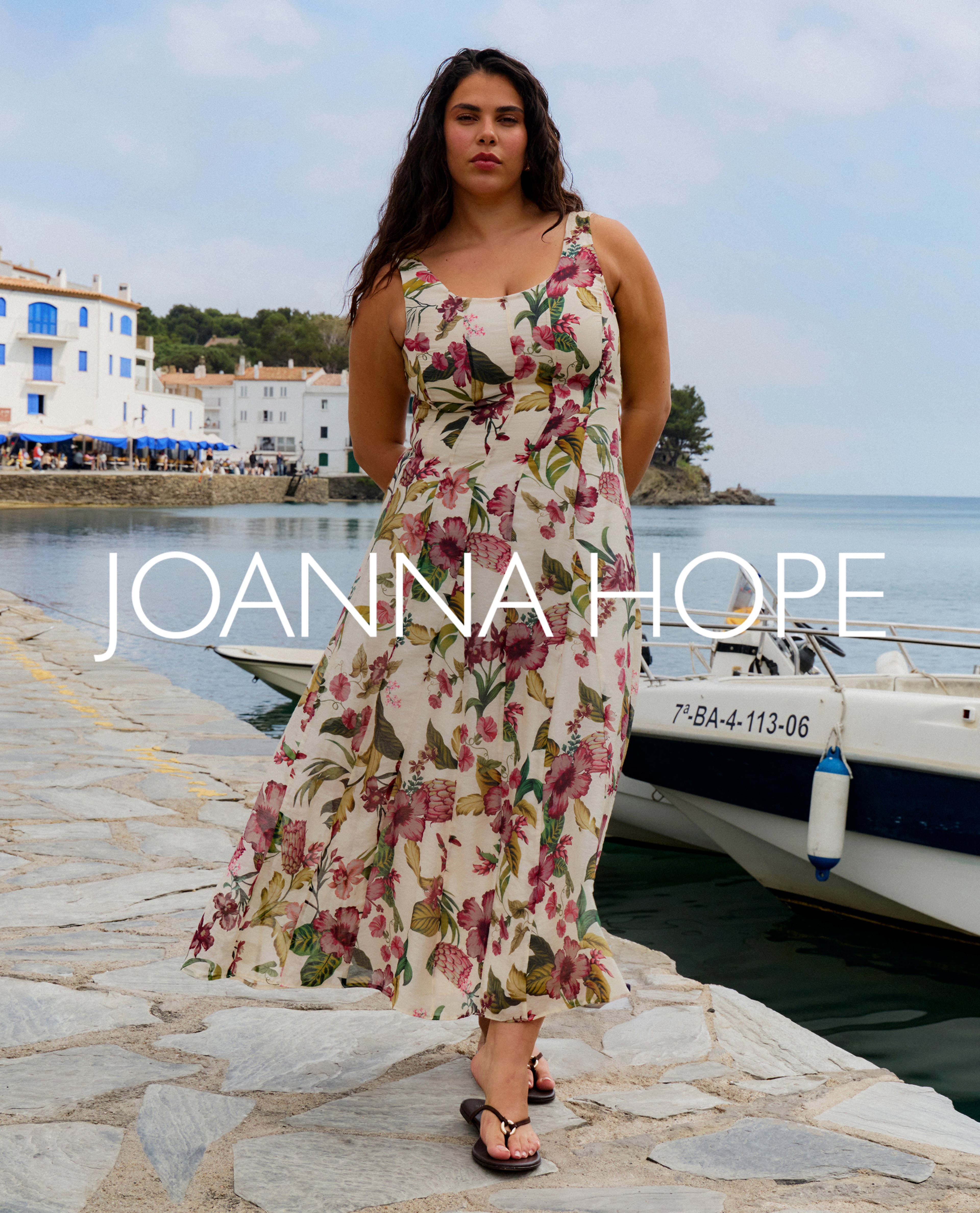 Model wears floral dress from Joanna Hope