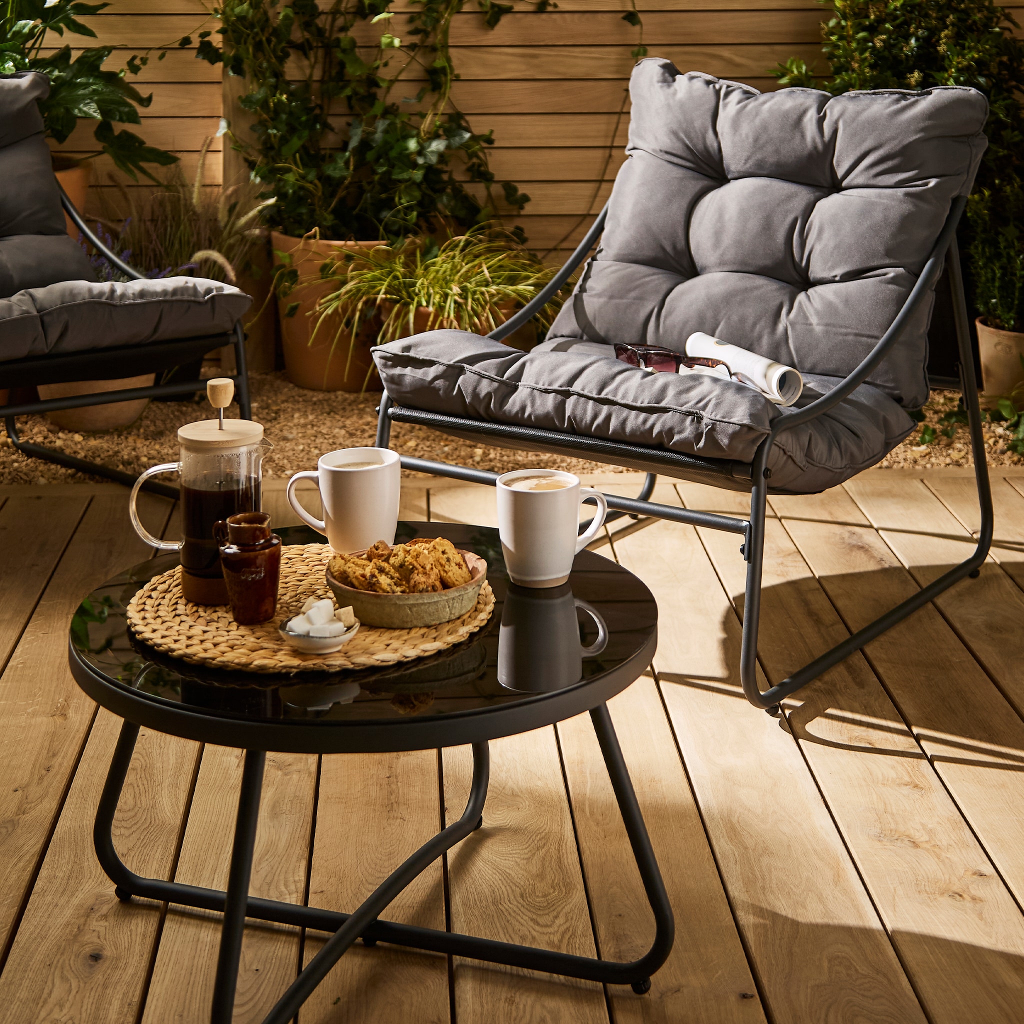 A comfortable grey armchair paired with a coffee table.
