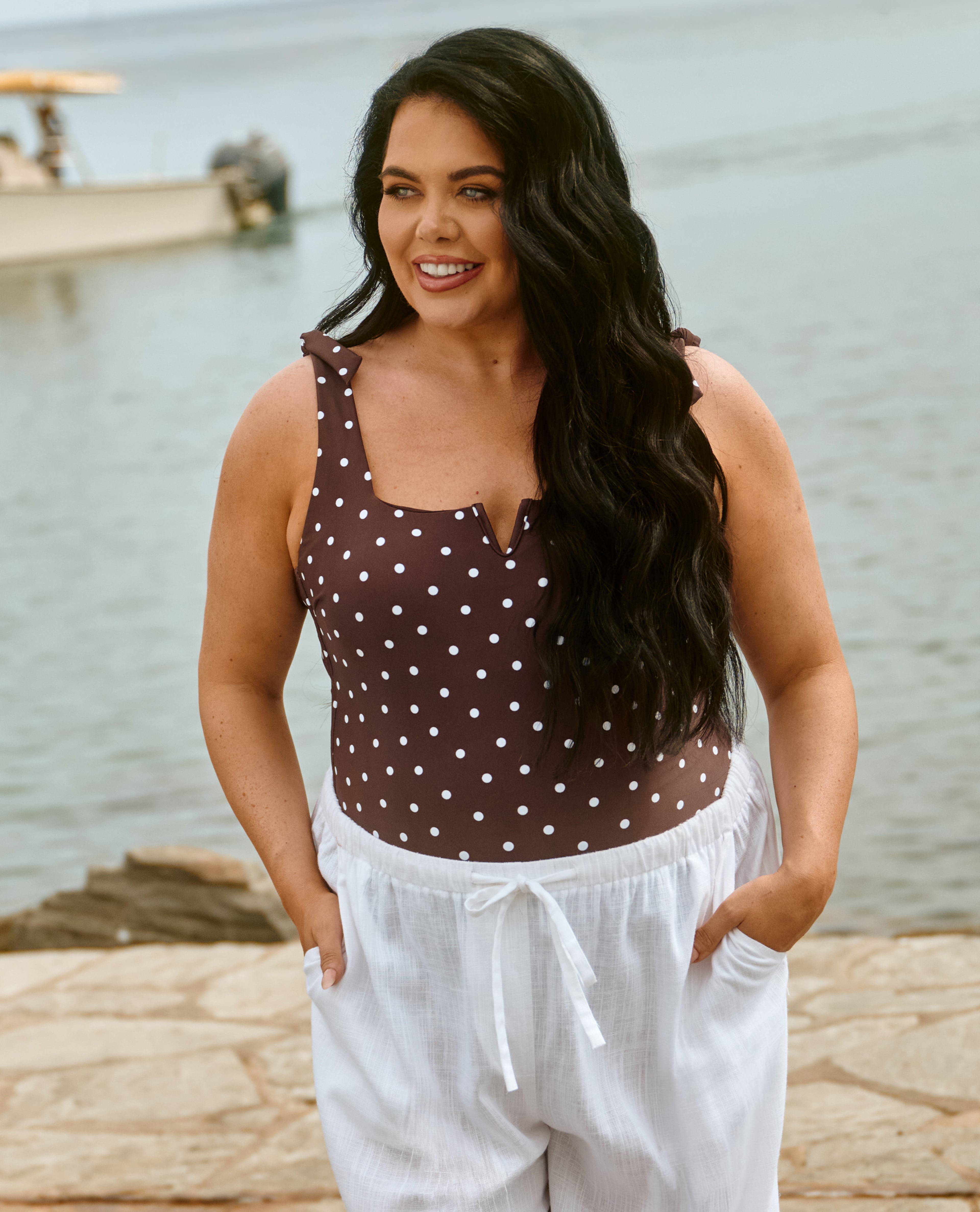 Scarlett Moffatt wears swimsuit and linen trousers