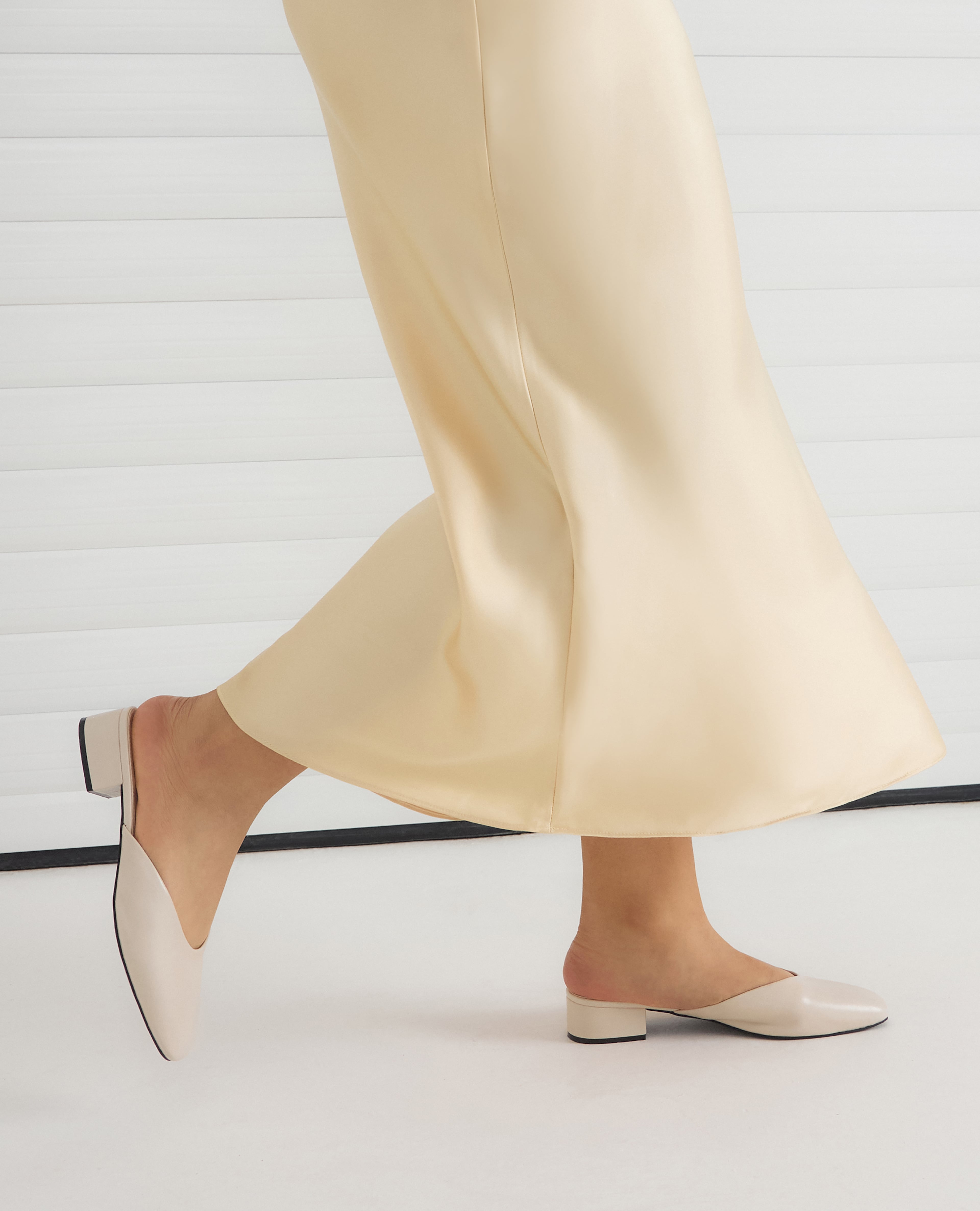 Model wears Lisa Low Block Heel Mules - Wide Fit (E) in Ecru