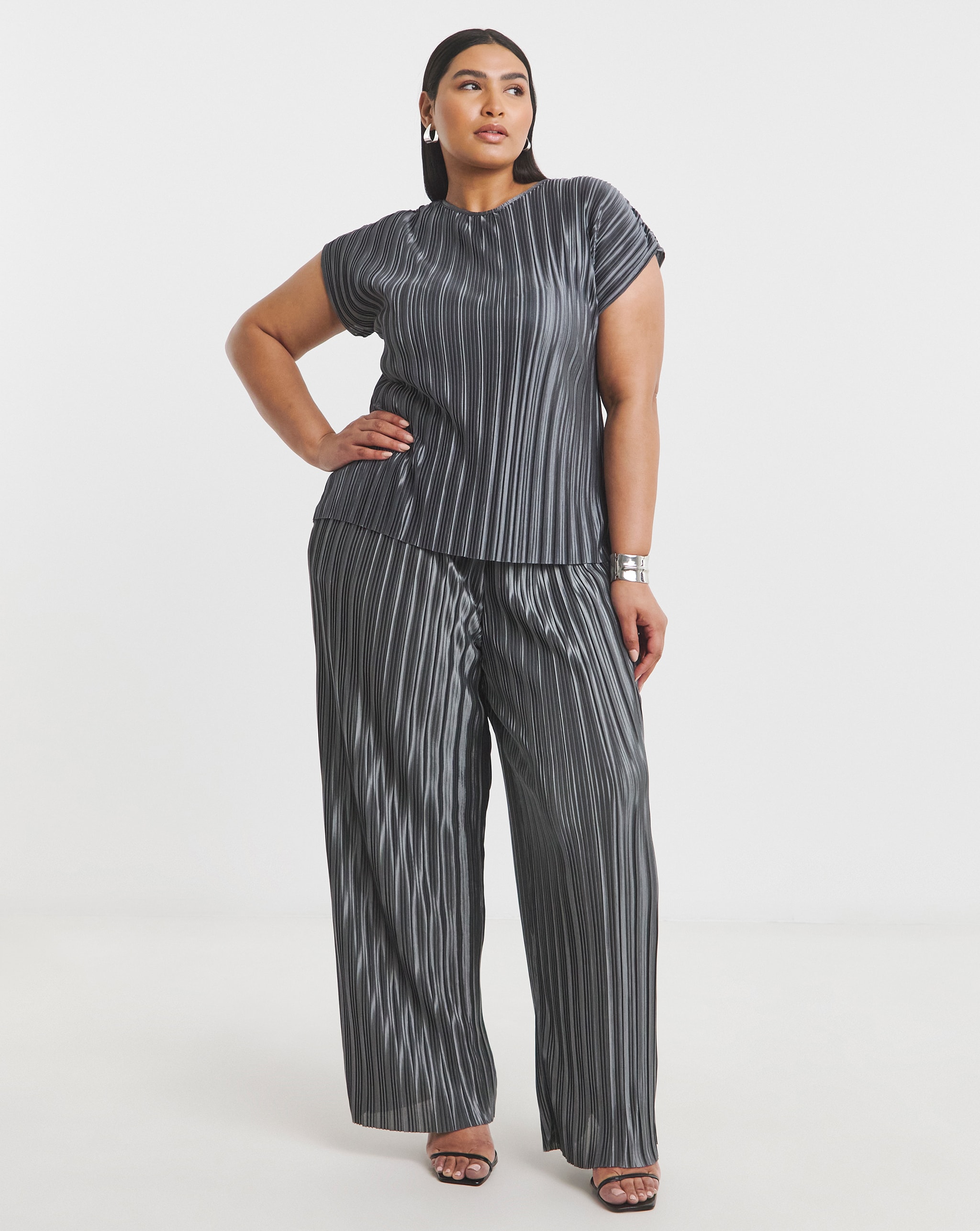 Model wears matching seperates in grey satin