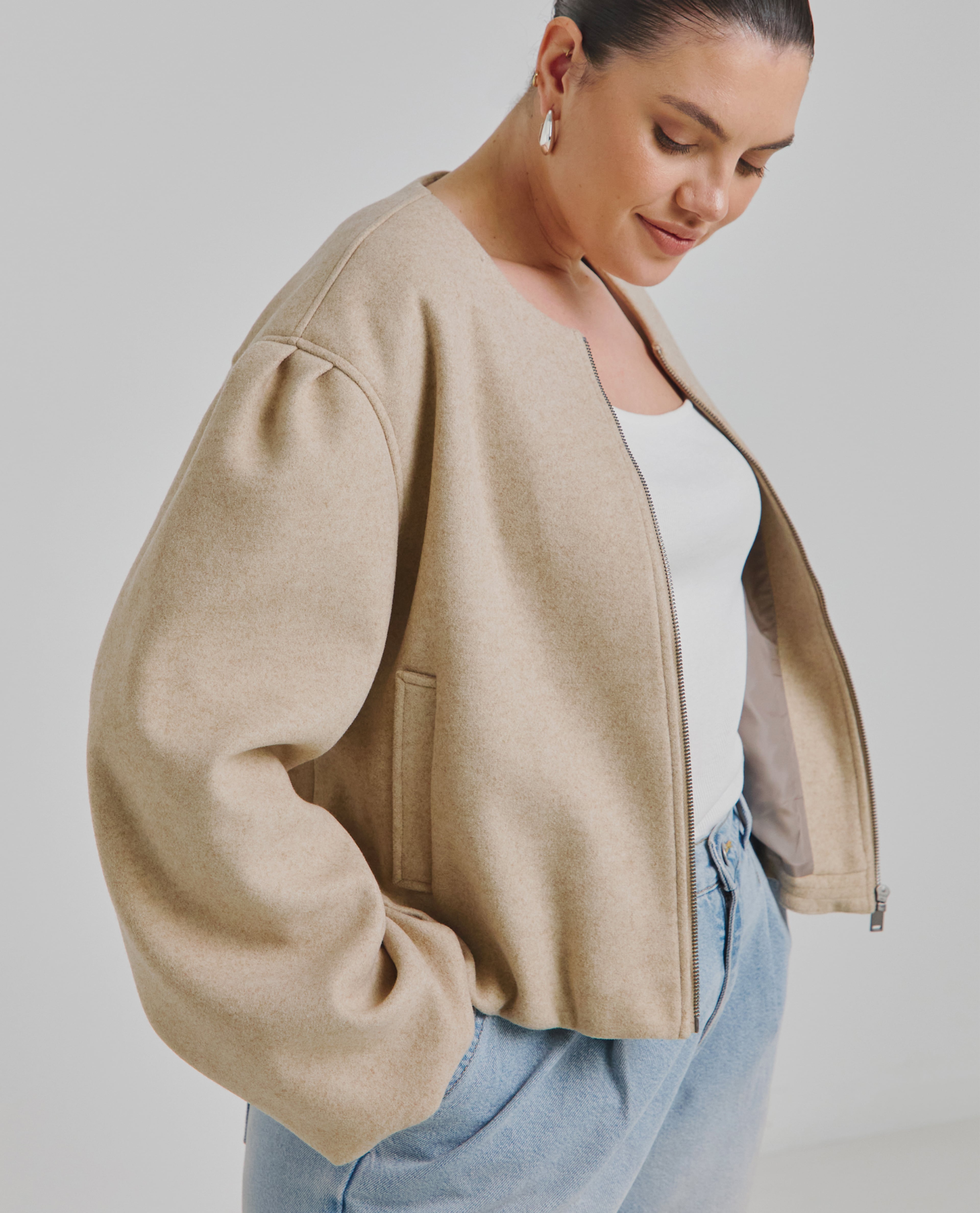 Model wears beige collarless jacket