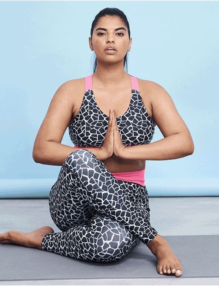 Model doing yoga wearing leopard print lycra leggings and top