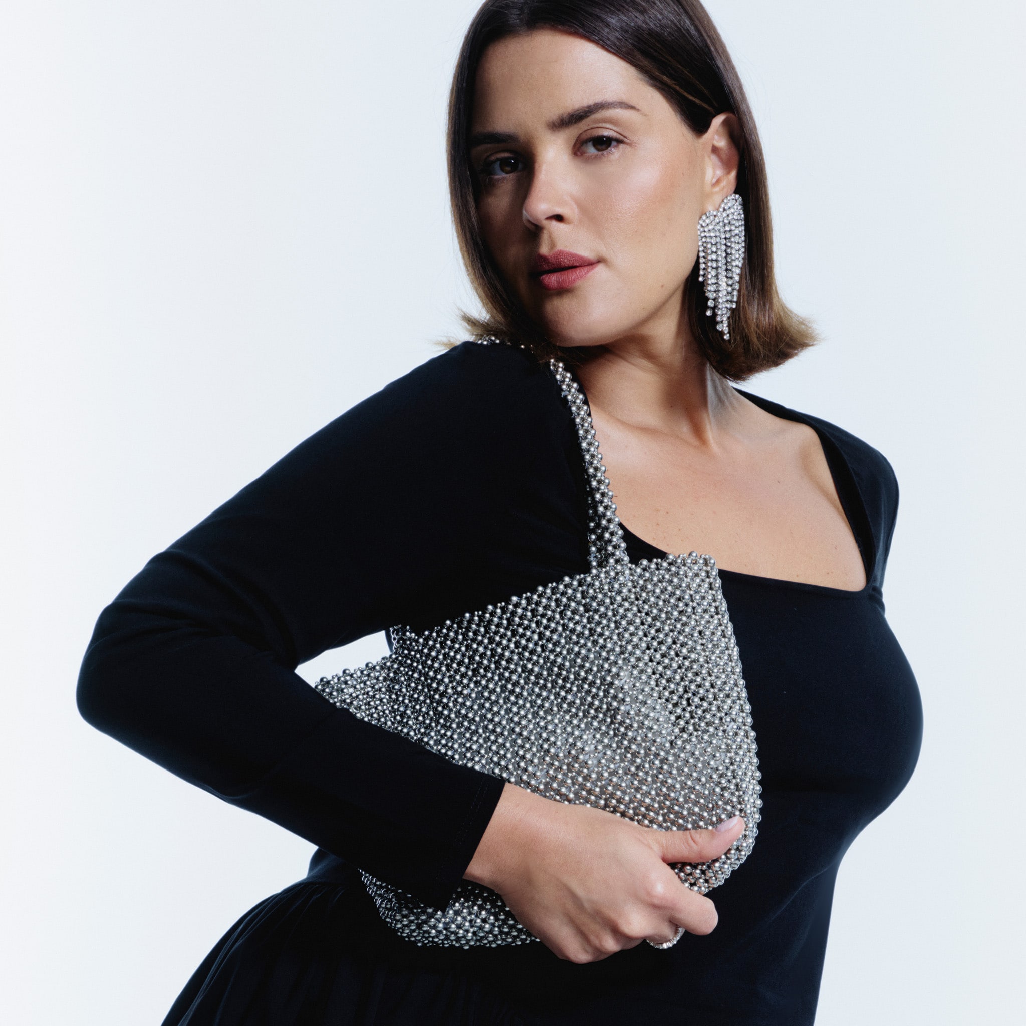 model wearing black dress with silver bag