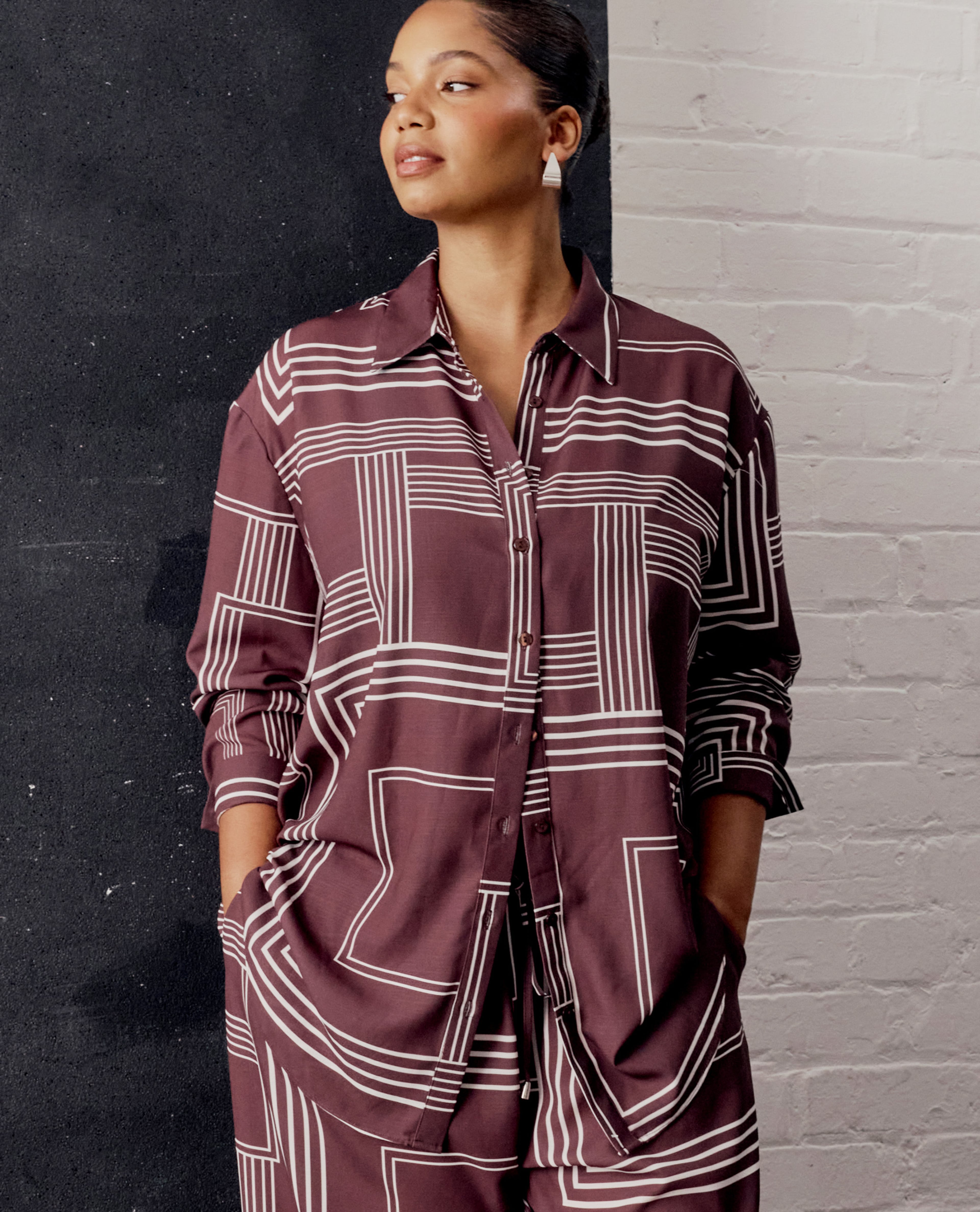 model wearing burgundy pattern top and trouser suit