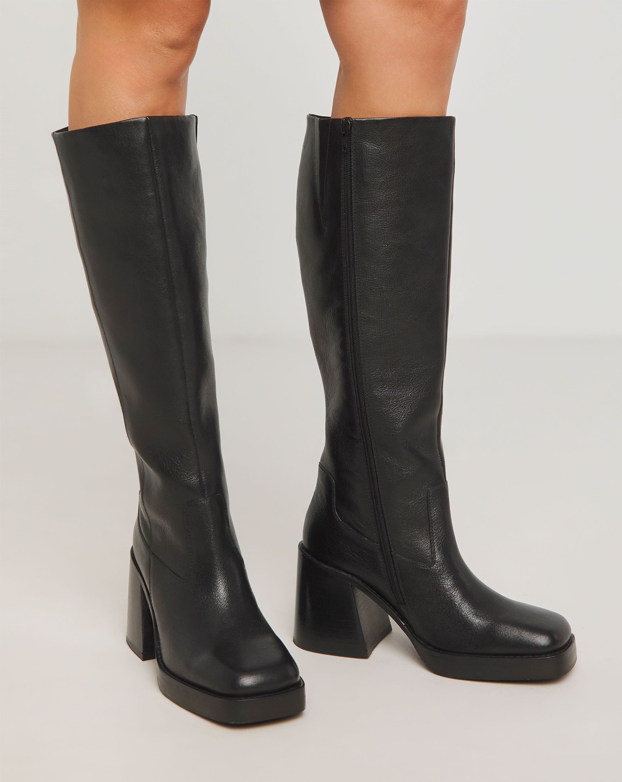 A pair of black knee high boots