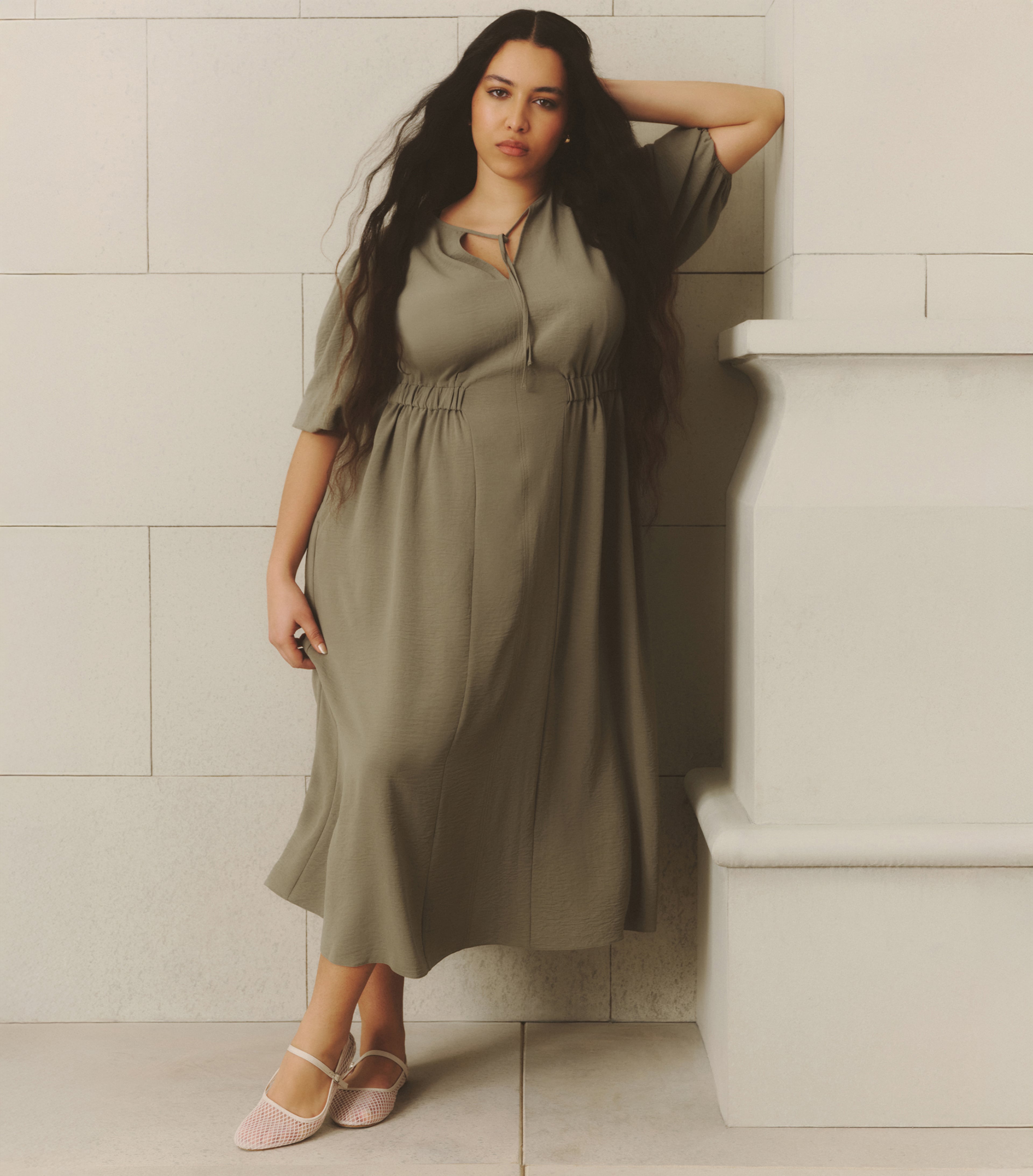 Model wears midi dress in khaki