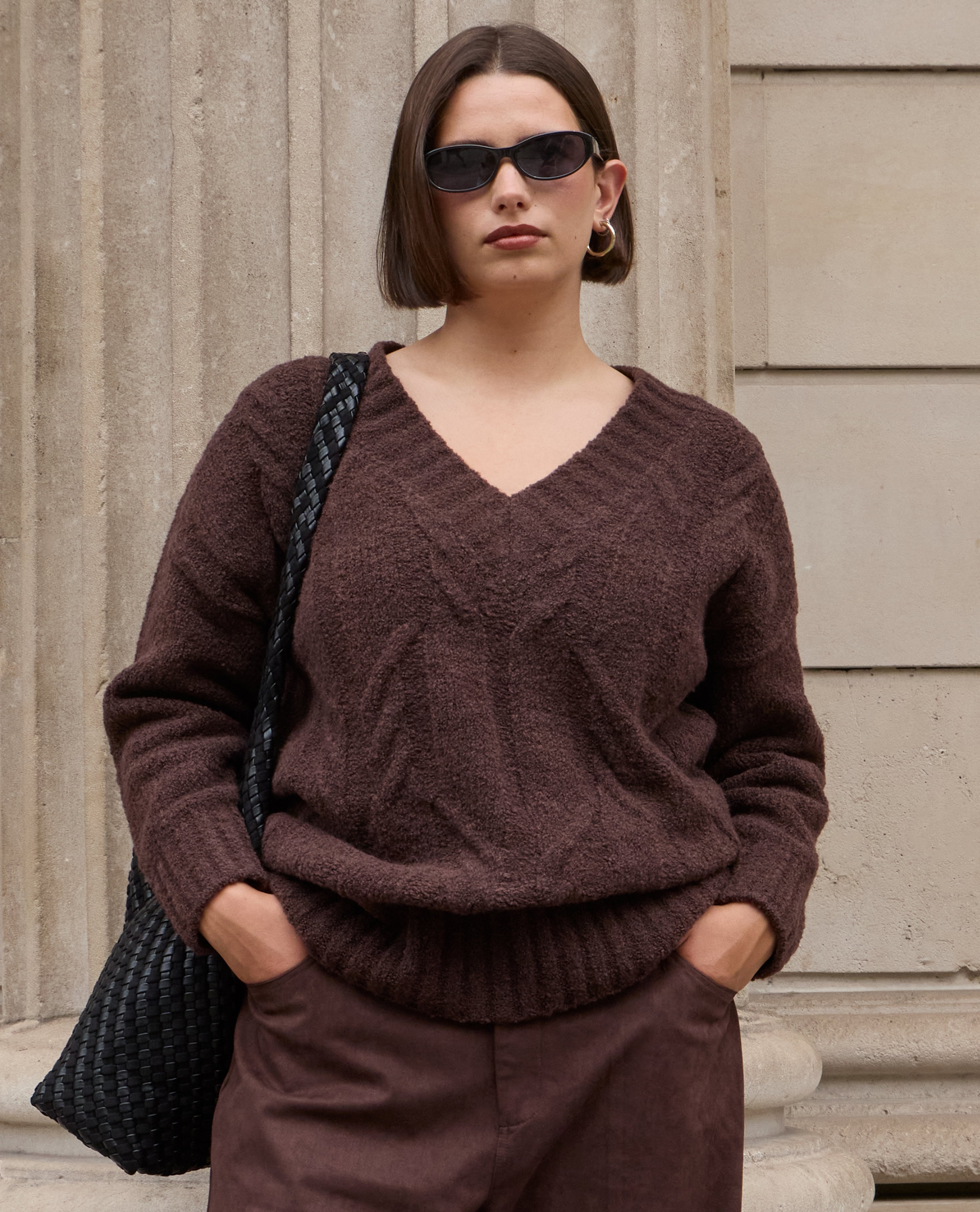 Model wears v-neck knit in chocolate