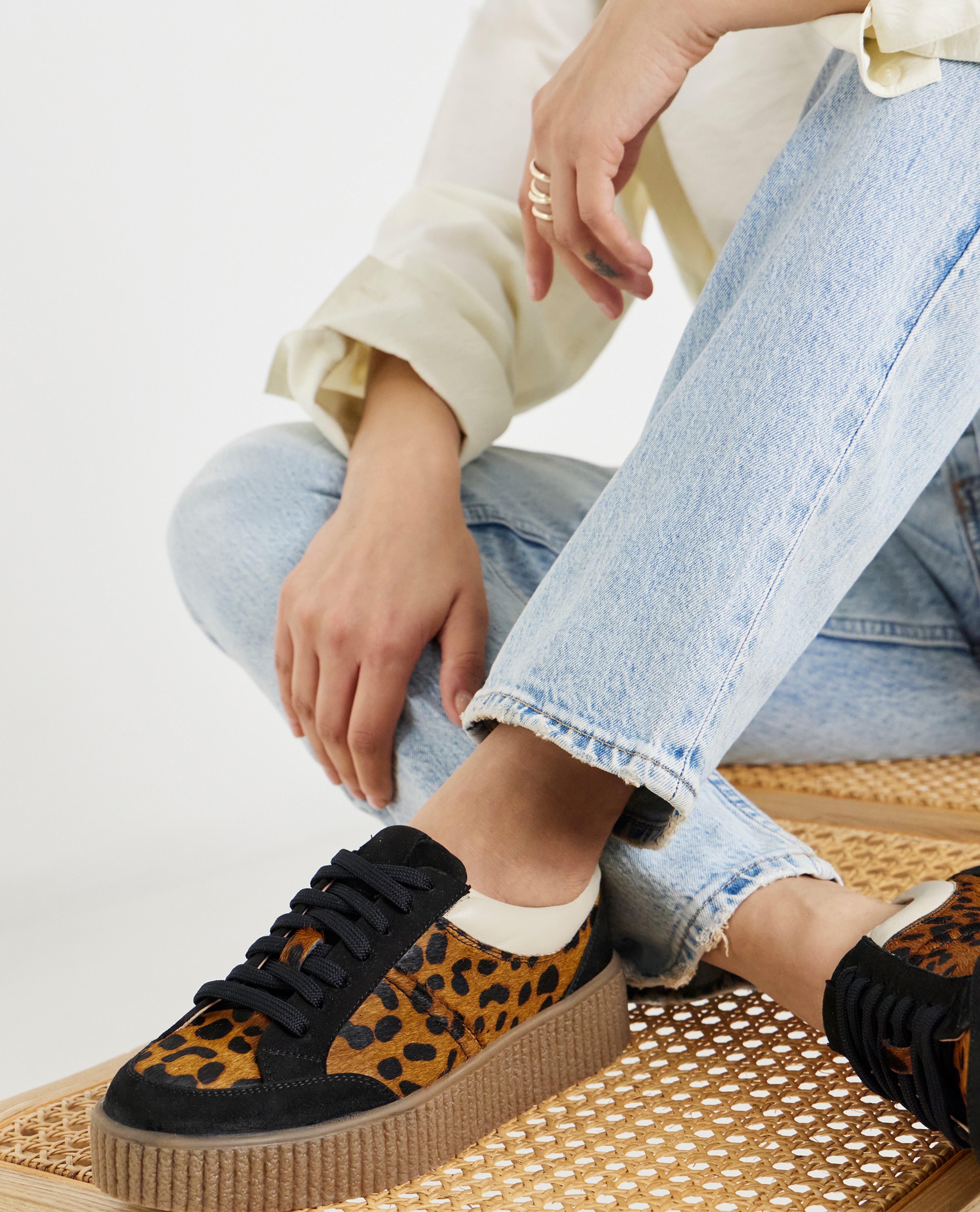 Model is wearing light blue jeans with Beth Leather chunky lace up leopard trainers