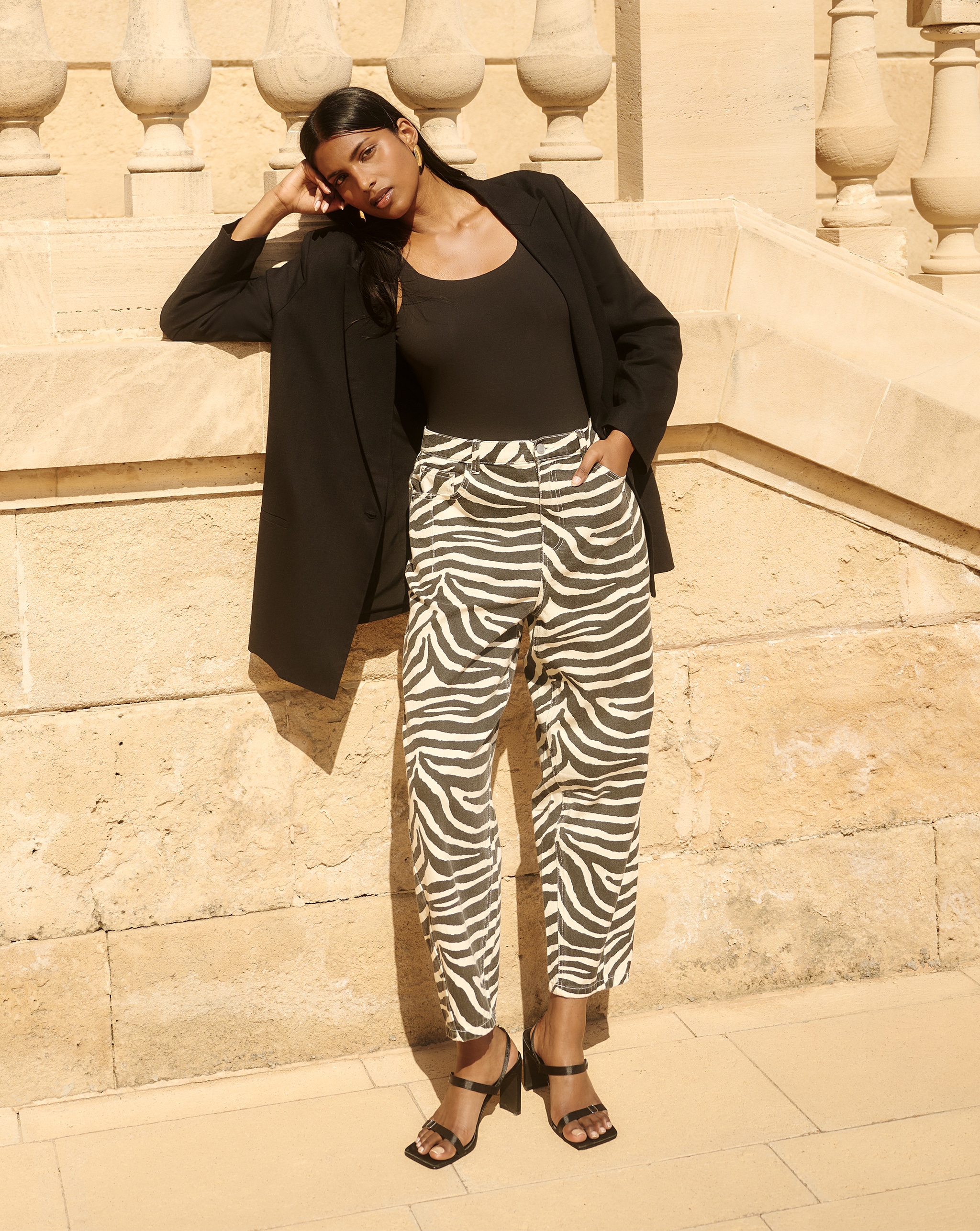 Model wears barrel jeans in zebra print