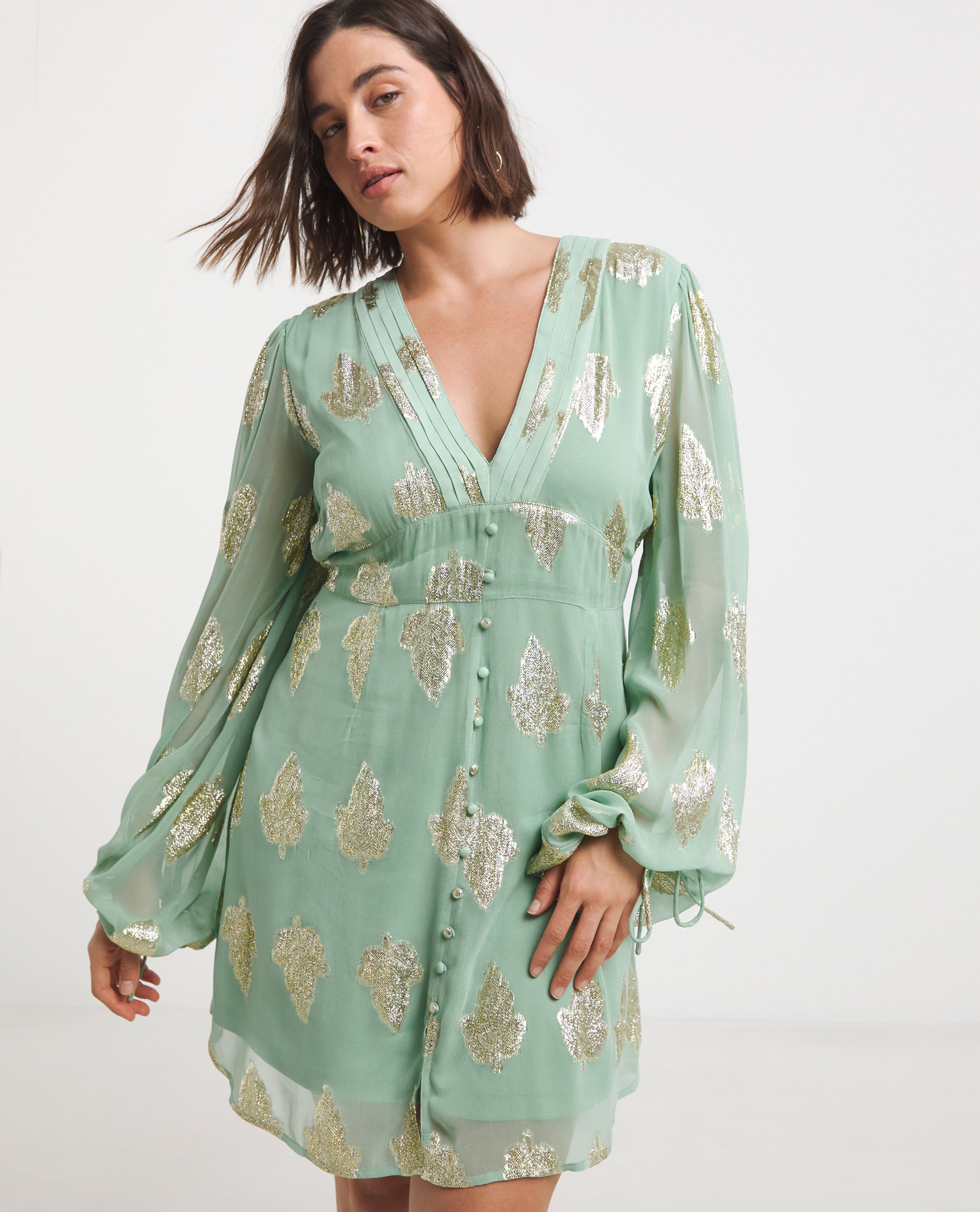 Model wears embroidered occasion dress in mint green
