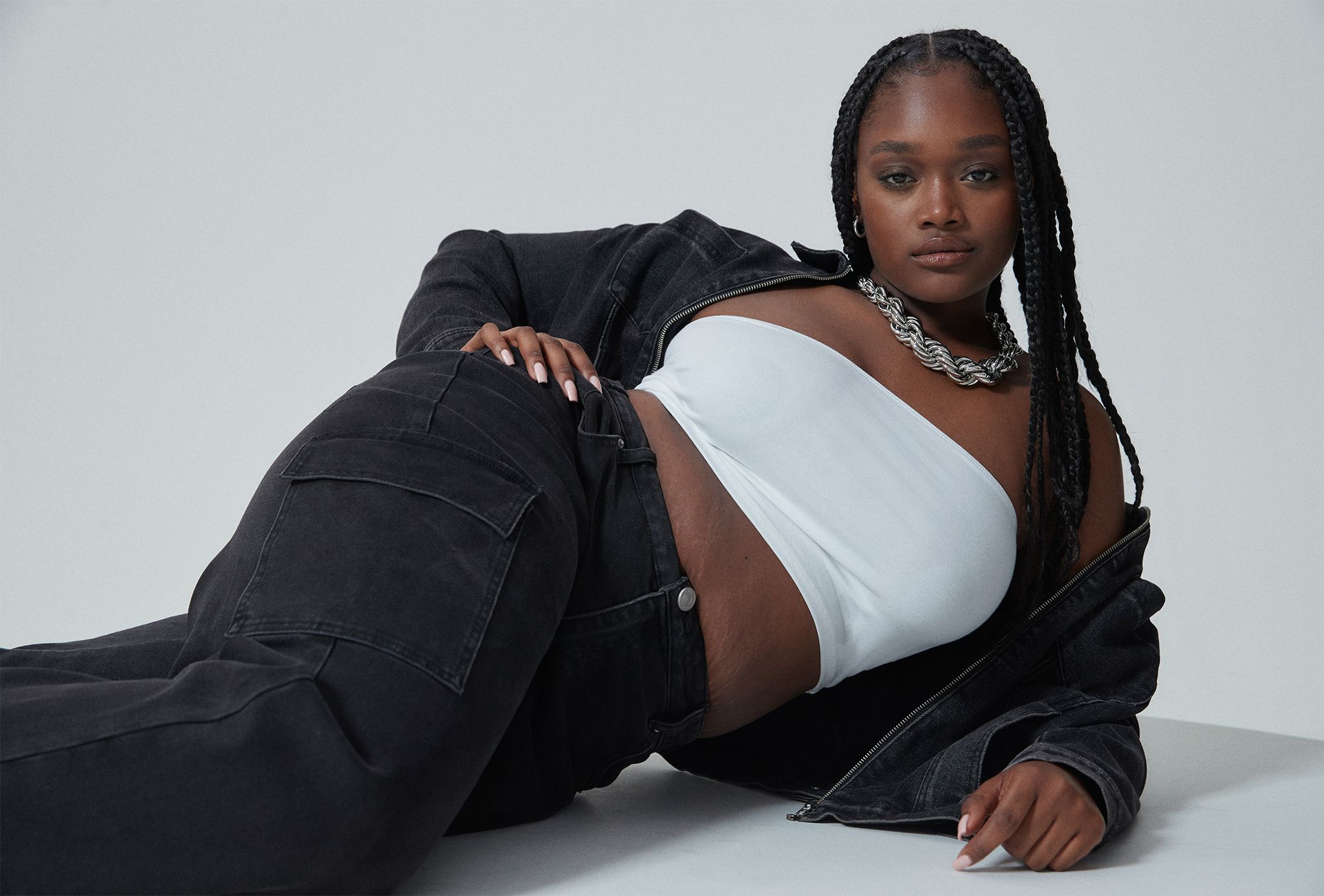 Model wearing black denim shirt and jeans