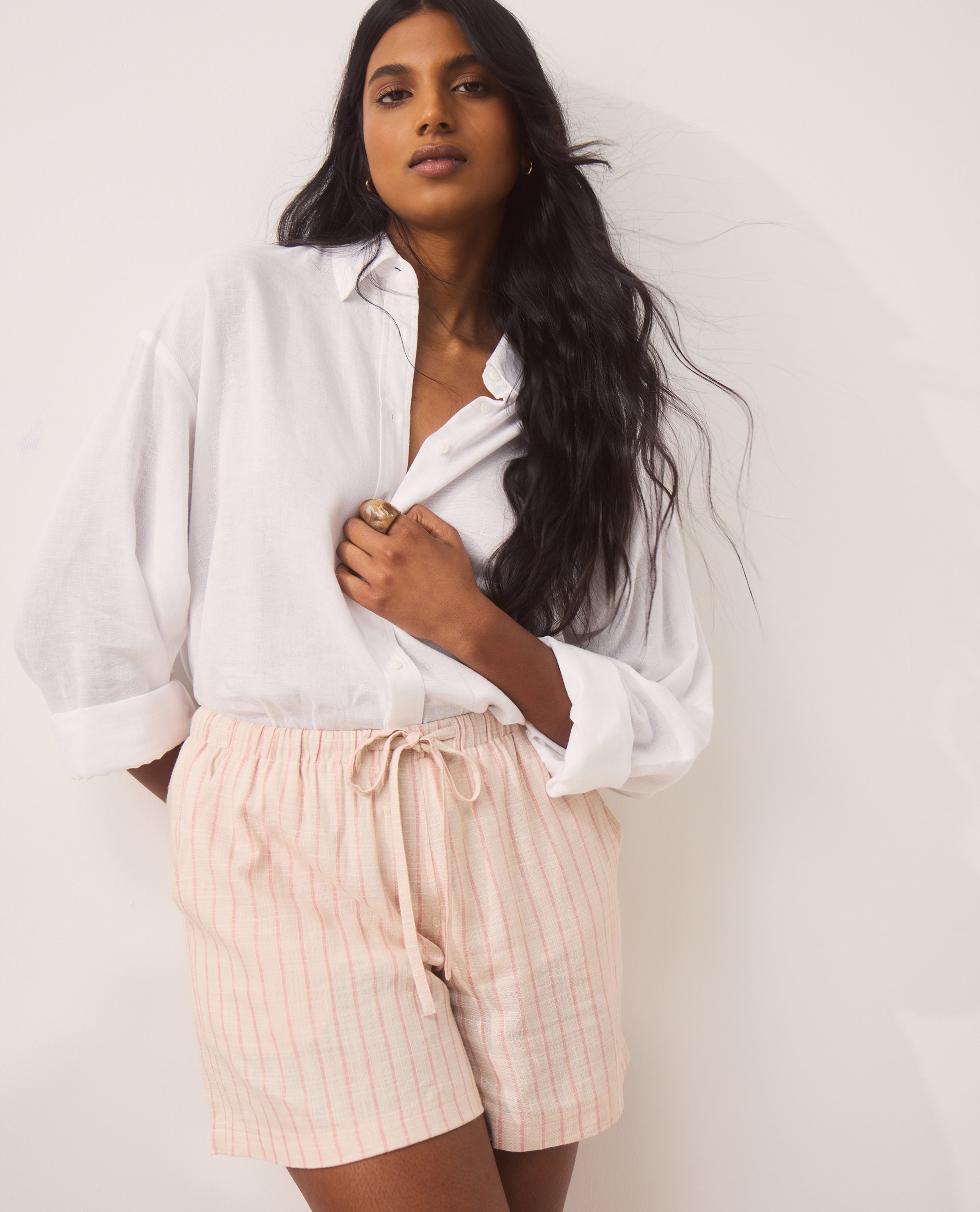 Model wears new season linen shirt and shorts