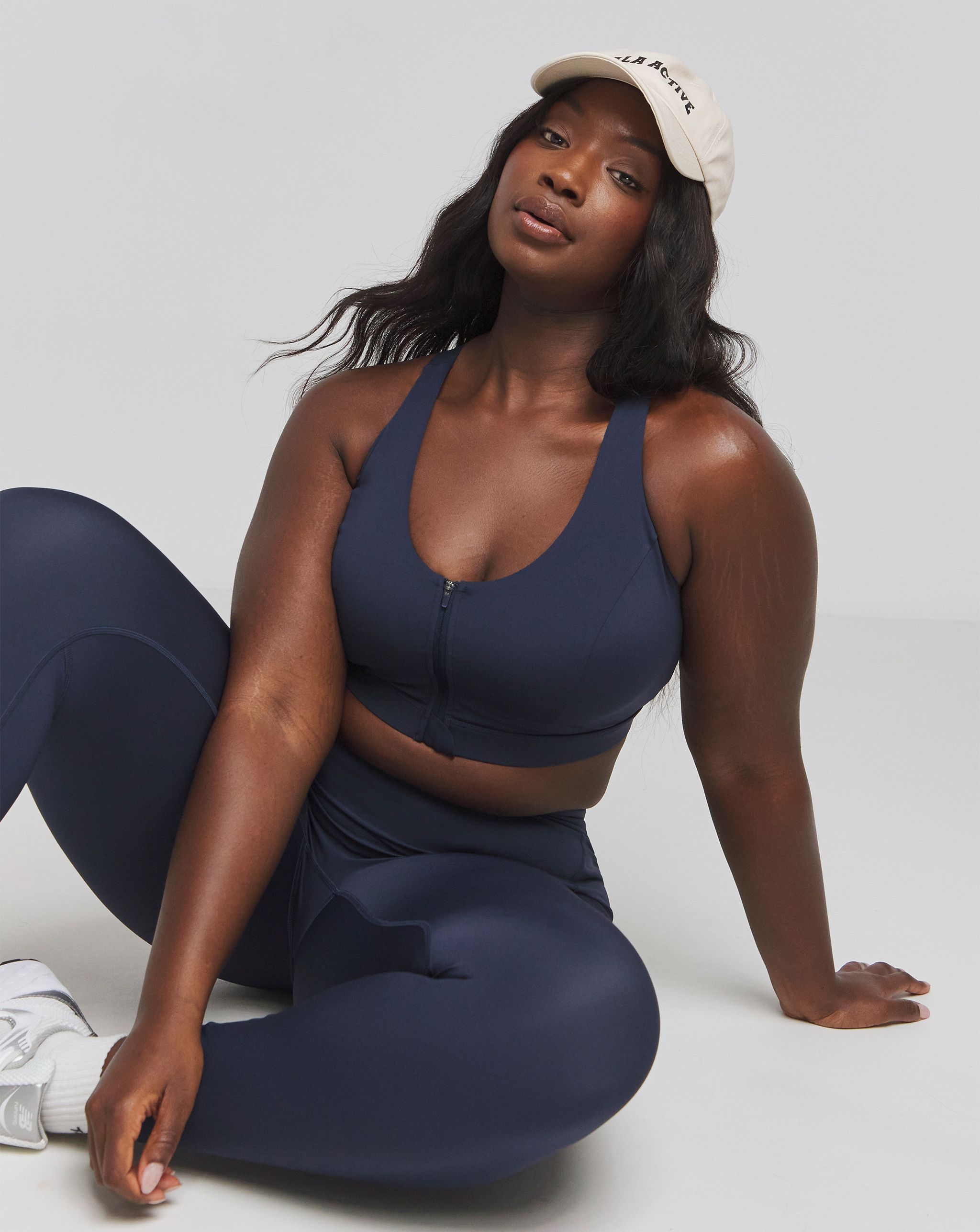 Model wears sports bra and leggings in navy
