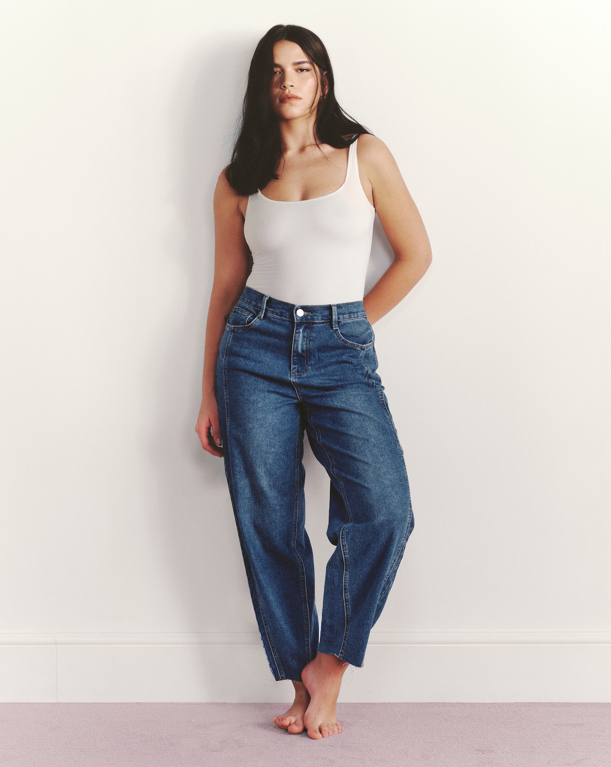 Model wears barrel jeans