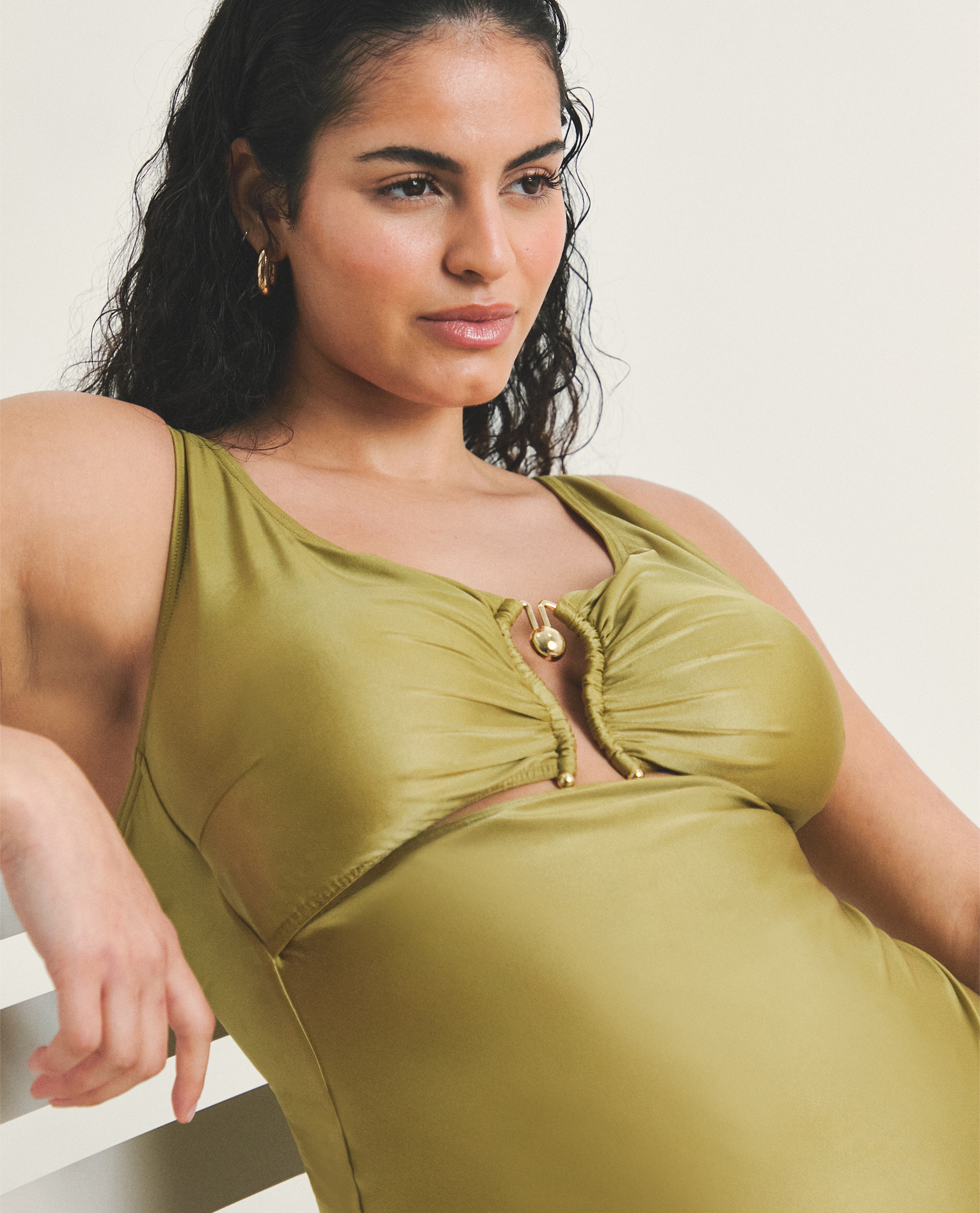 Model wears swimsuit in olive