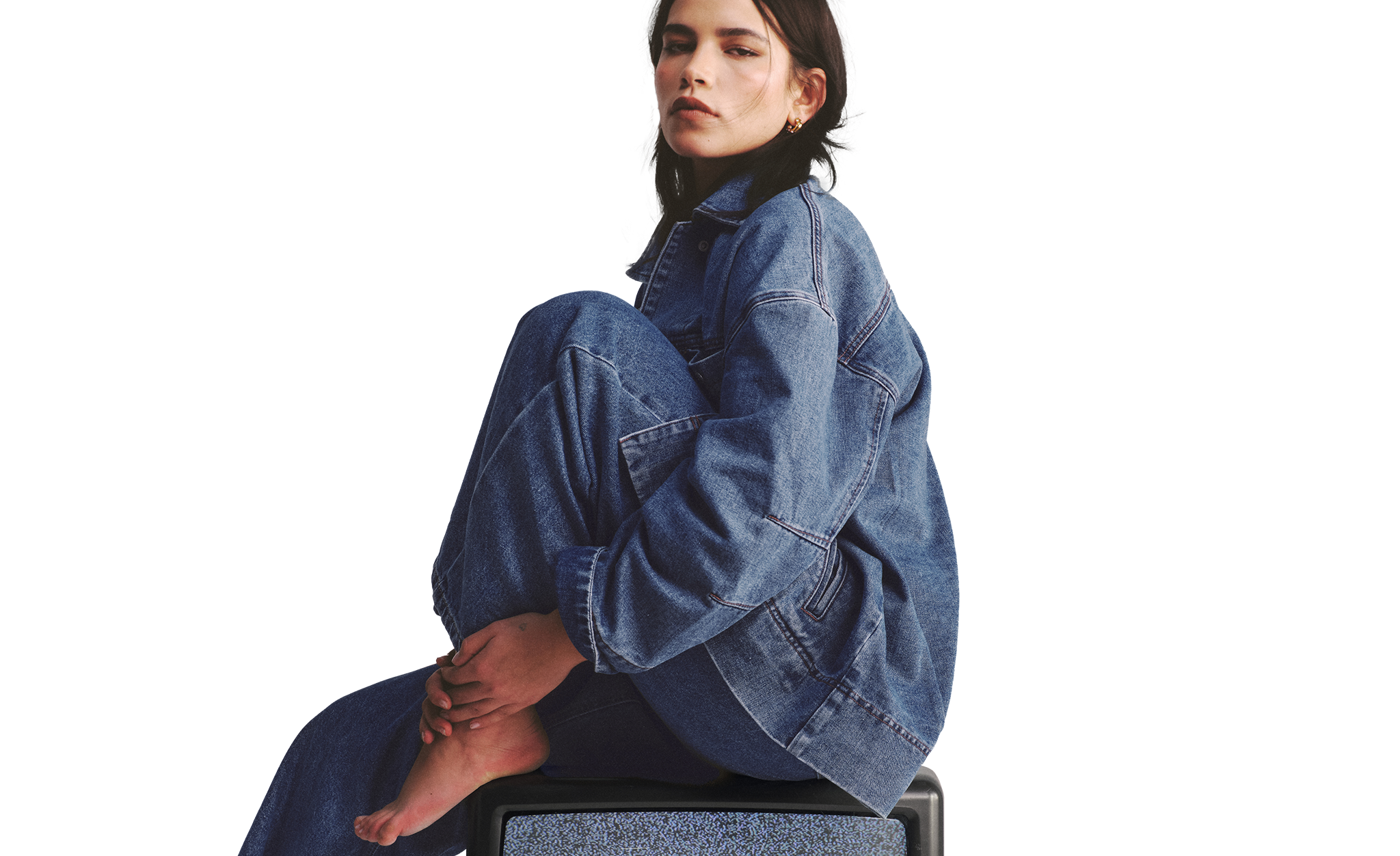 Model wears denim shirt and jeans