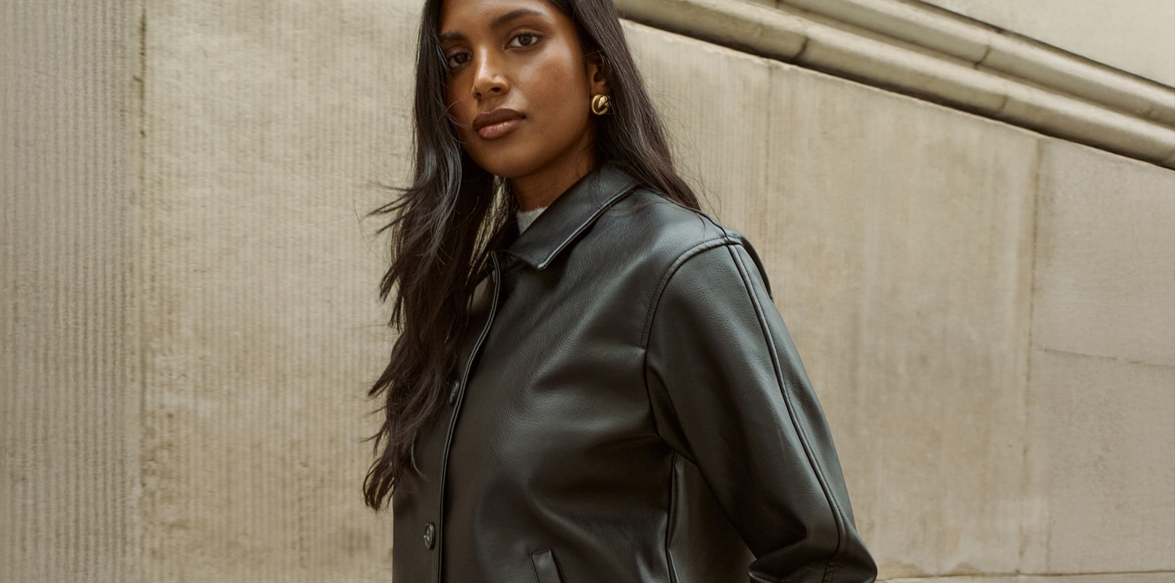 Model wears black leather jacket