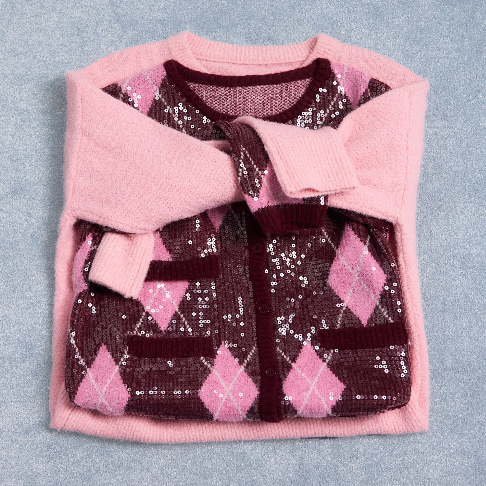 Xmas jumper styled flat with arms wrapped at the front