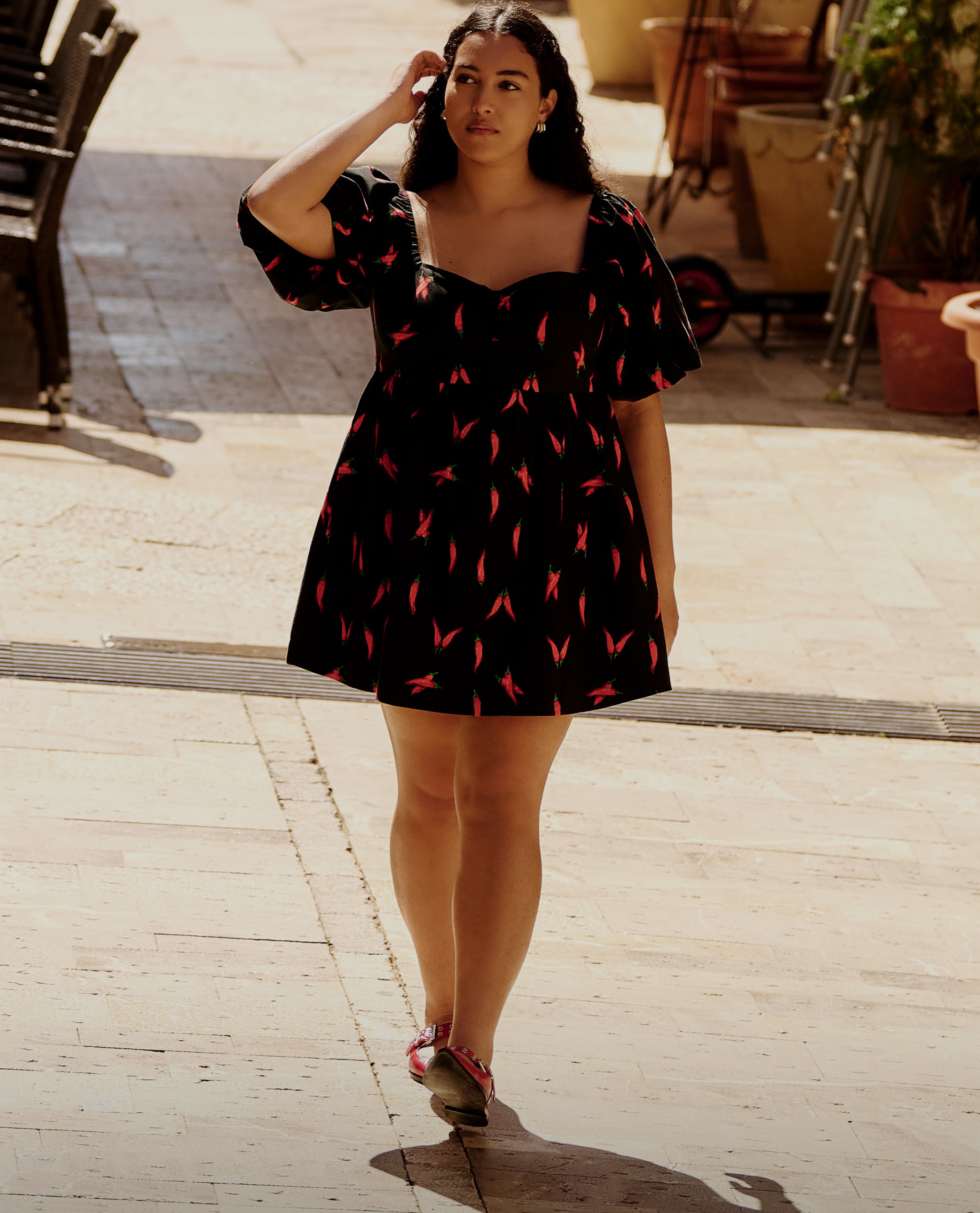 Model wearing short dress black and red 