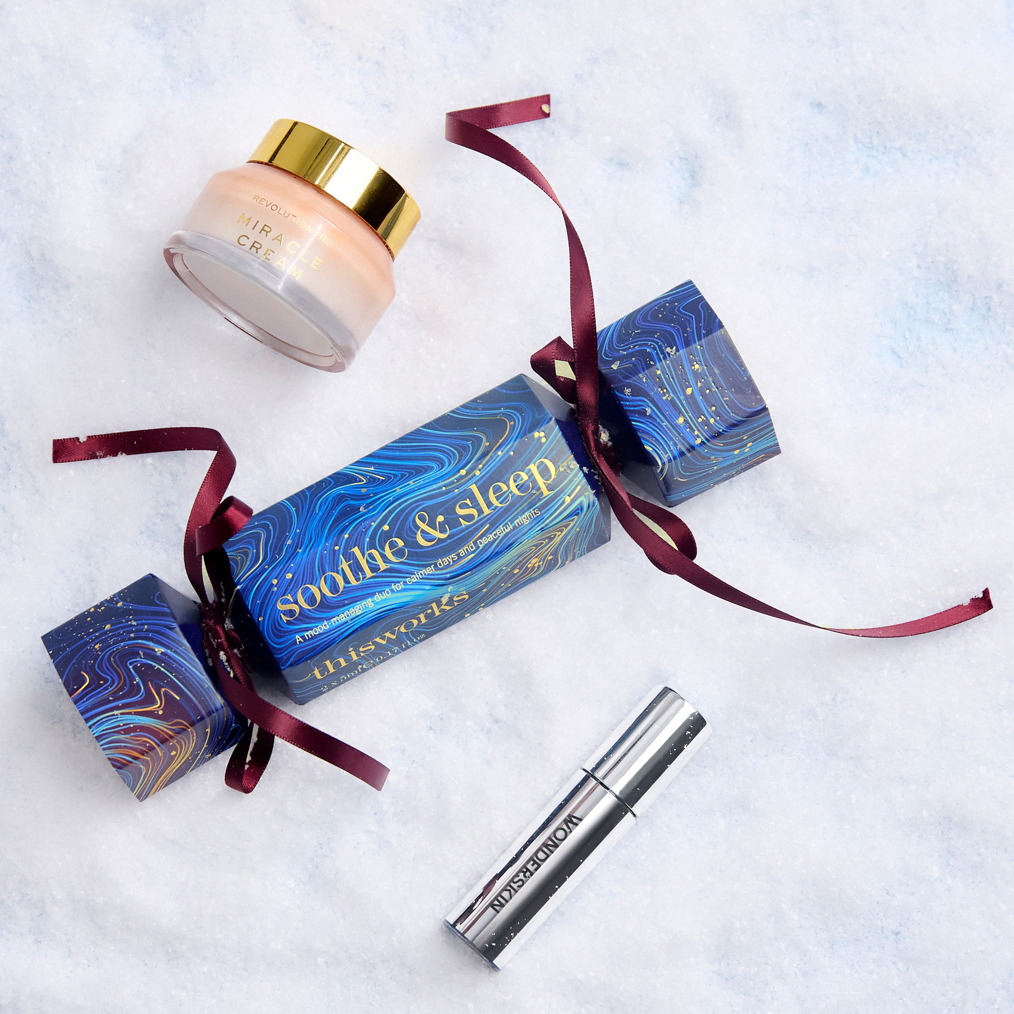 gifting a cracker showing beauty products with red bow