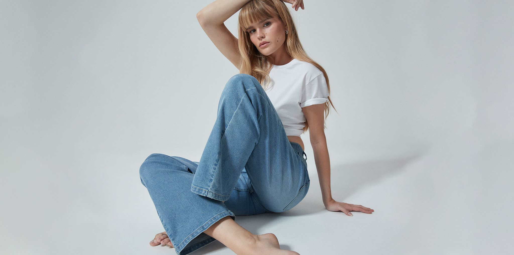 Model wearing light blue 24/7 dad jeans
