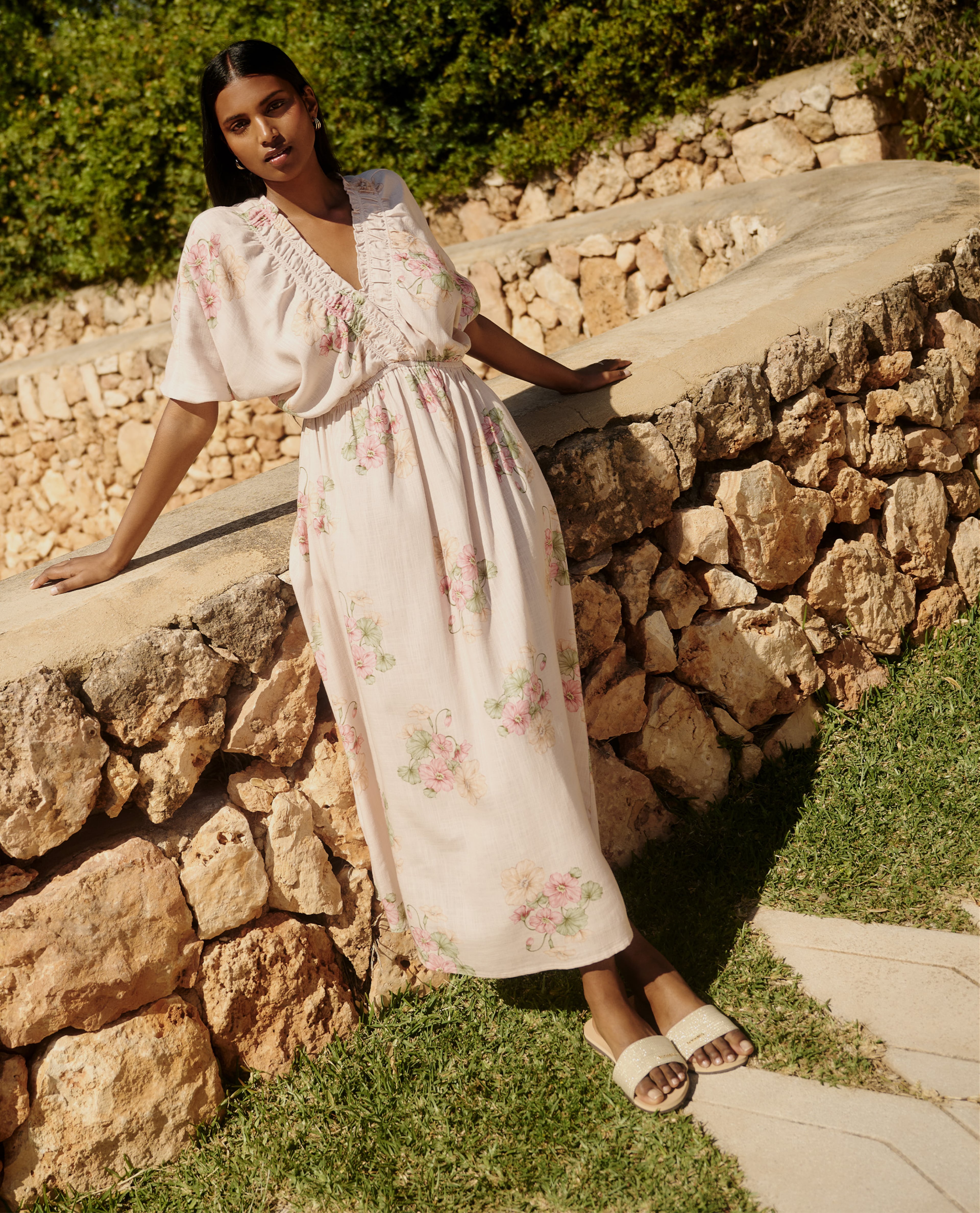 Model wearing white flowered long dress