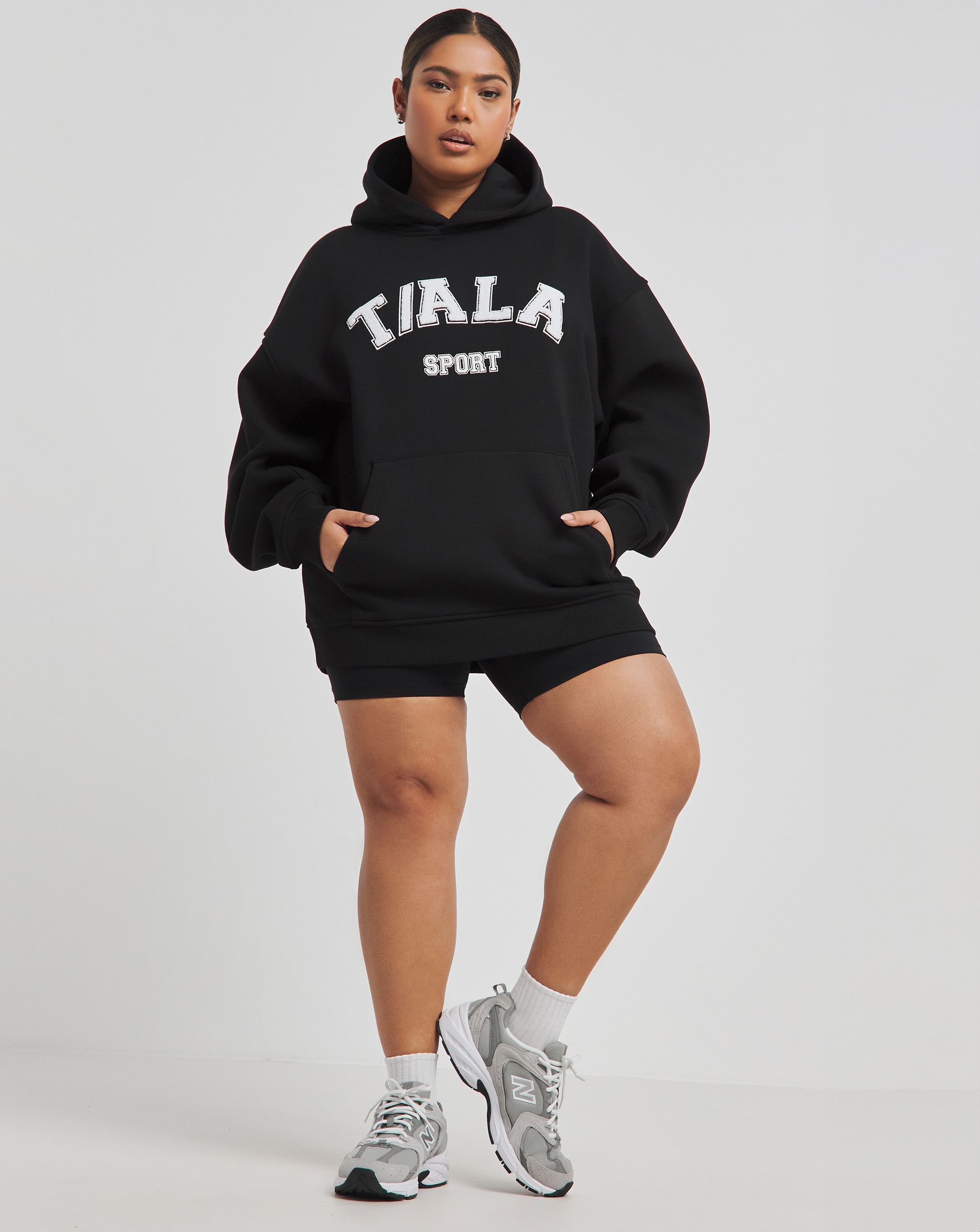 Model wears TALA hoody and cycling shorts