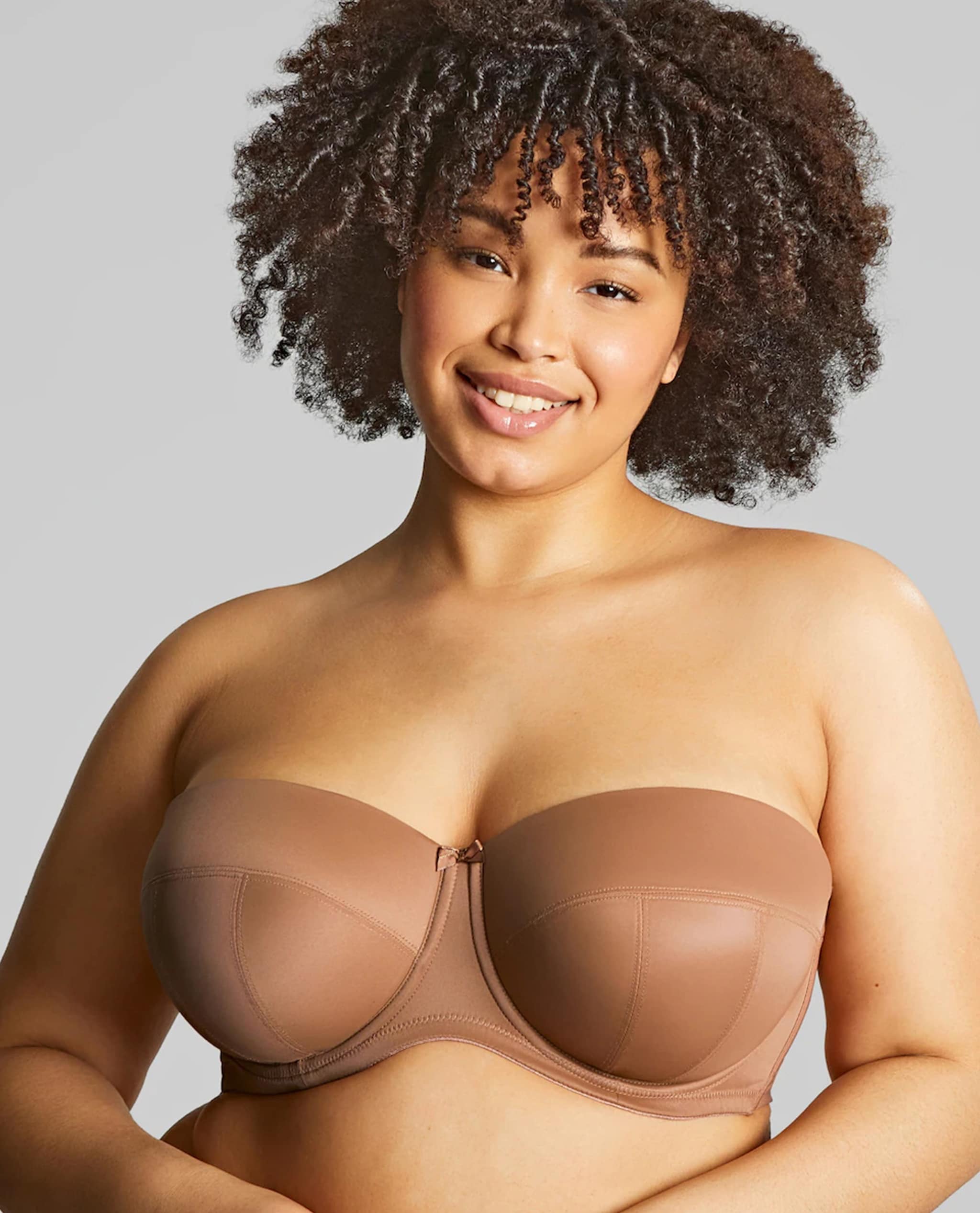 Model is wearing a Sculptresse by Panache Dana strapless wired bra in caramel