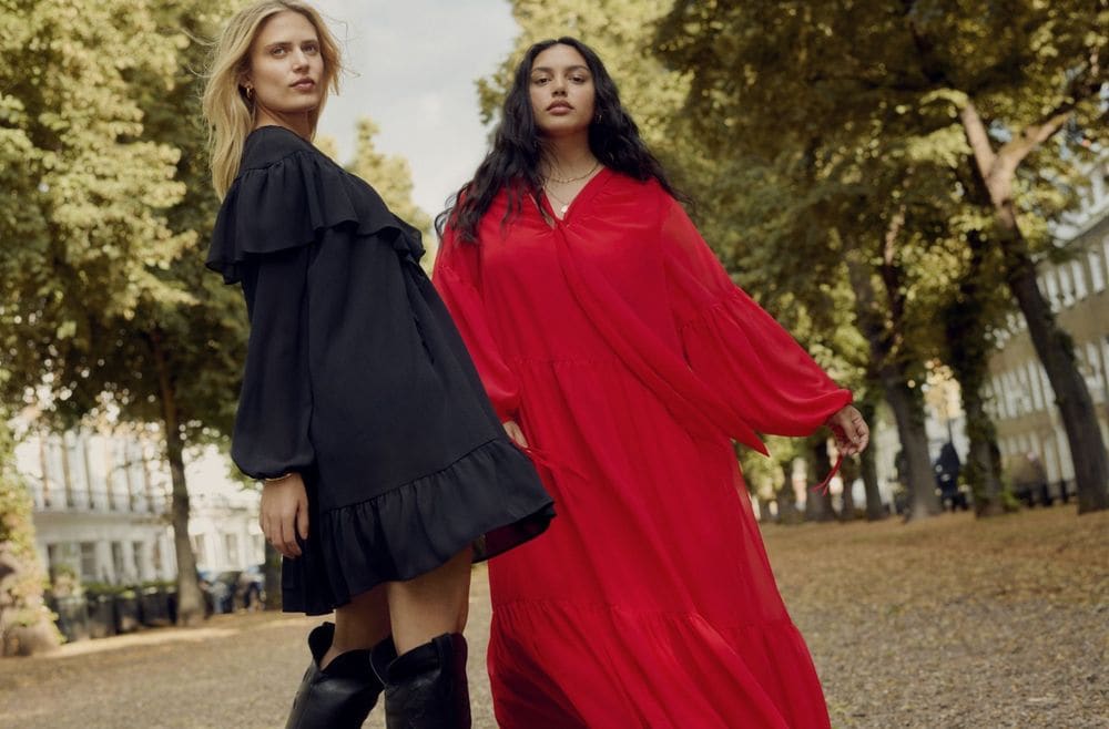 two women wearing dresses