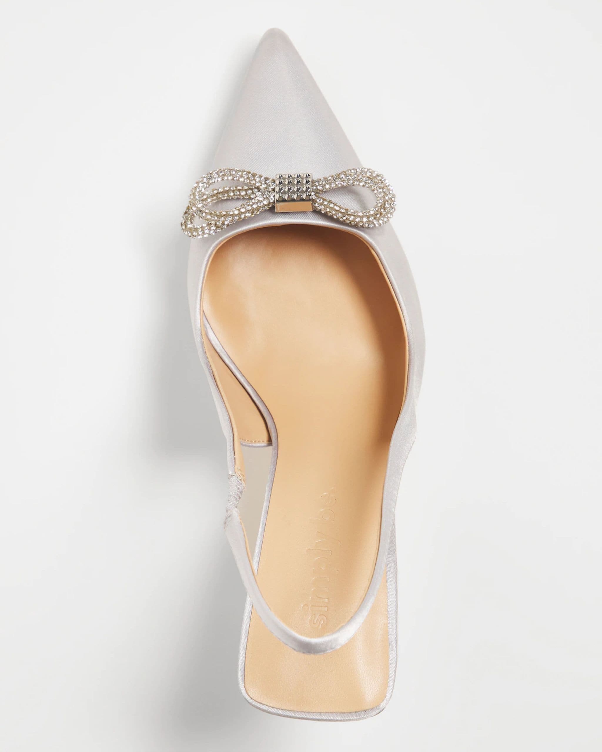 A silver dress show with a bow