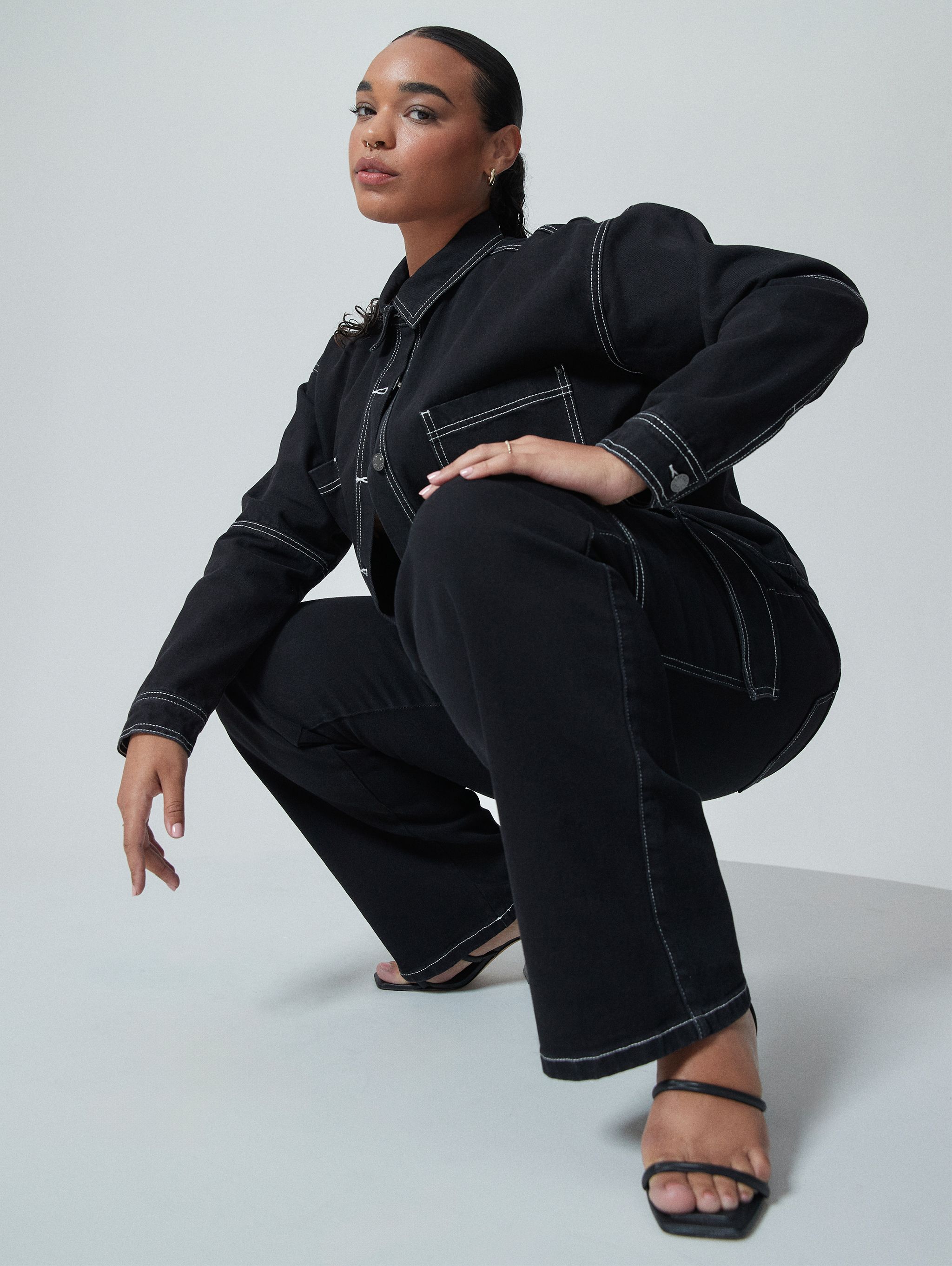 Model wearing contrast stitch denim jacket and jeans