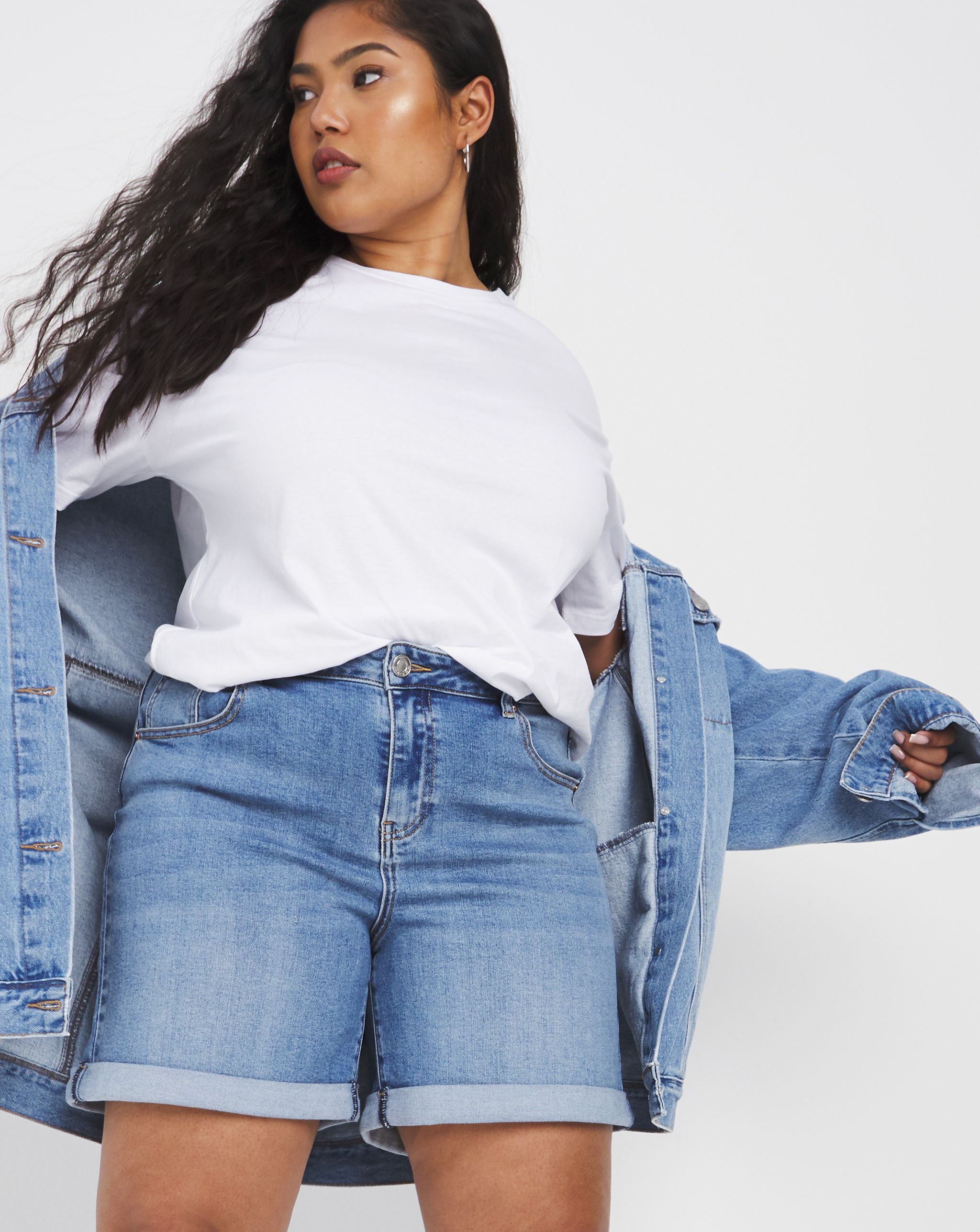 model wearing white t-shirt with denim shorts and denim jacket