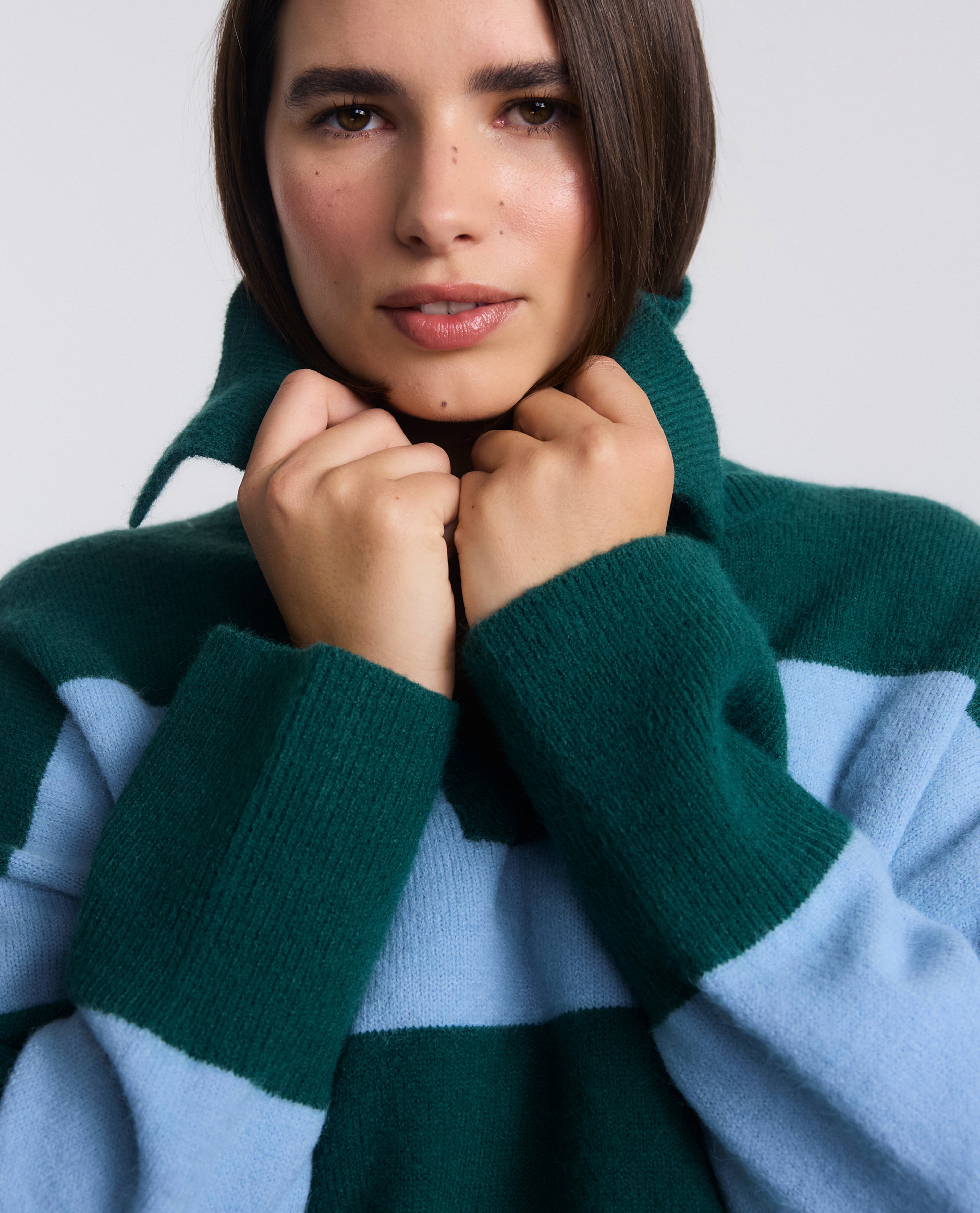 Model wears blue and green striped knit